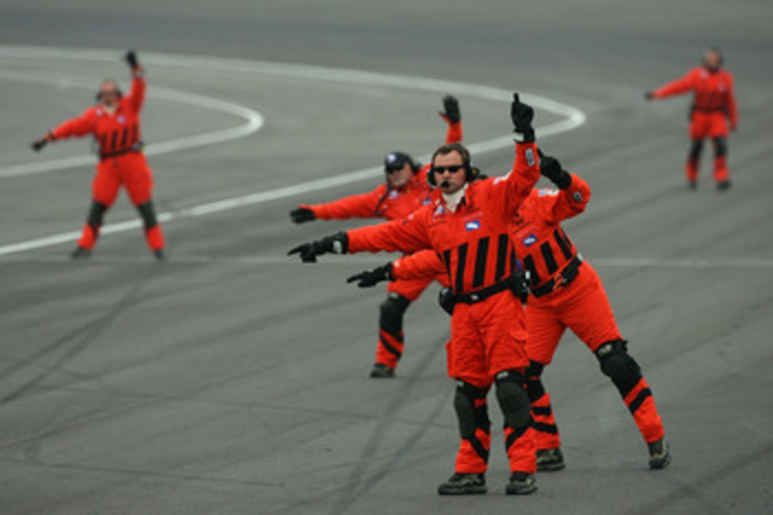 INDIANAPOLIS - MAY 27:  Members of the Delphi Safety crew direct cars towards the inside of the track as the race goes under caution during the IRL IndyCar Series 91st running of the Indianapolis 500 at the Indianapolis Motor Speedway on May 27, 2007 in I