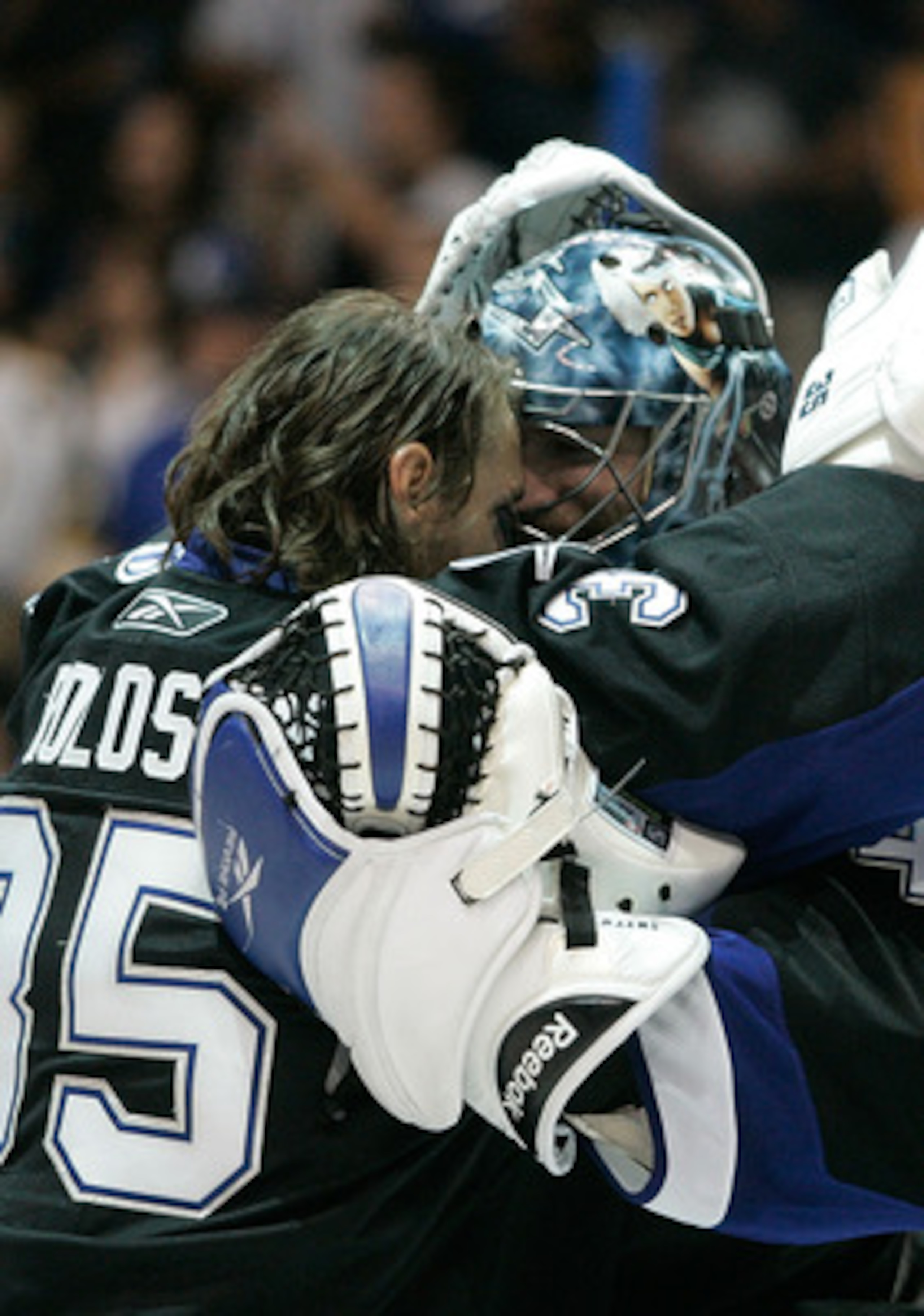 TAMPA, FL - MAY 21:  Dwayne Roloson #35 hugs Mike Smith #41 of the Tampa Bay Lightning after they defeated the Boston Bruins 5 to 3 in Game Four of the Eastern Conference Finals during the 2011 NHL Stanley Cup Playoffs at St Pete Times Forum on May 21, 20
