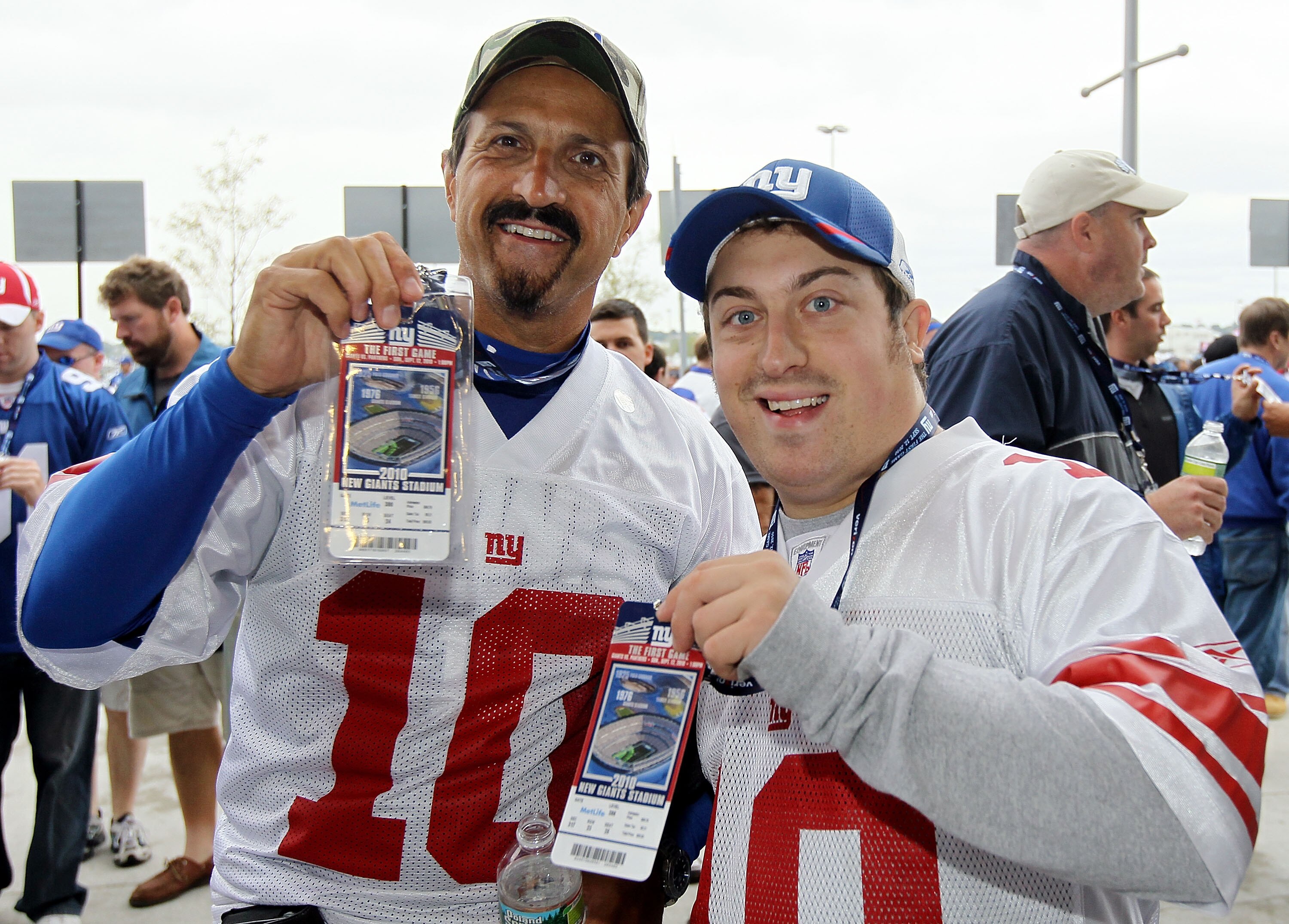 EAST RUTHERFORD, NJ - SEPTEMBER 12:  Jeremy (L) and Christopher Frajetti of New Jersey display their tickets to the first game at the New Meadowlands Stadium between the Carolina Panthers and the New York Giants on September 12, 2010  in East Rutherford,