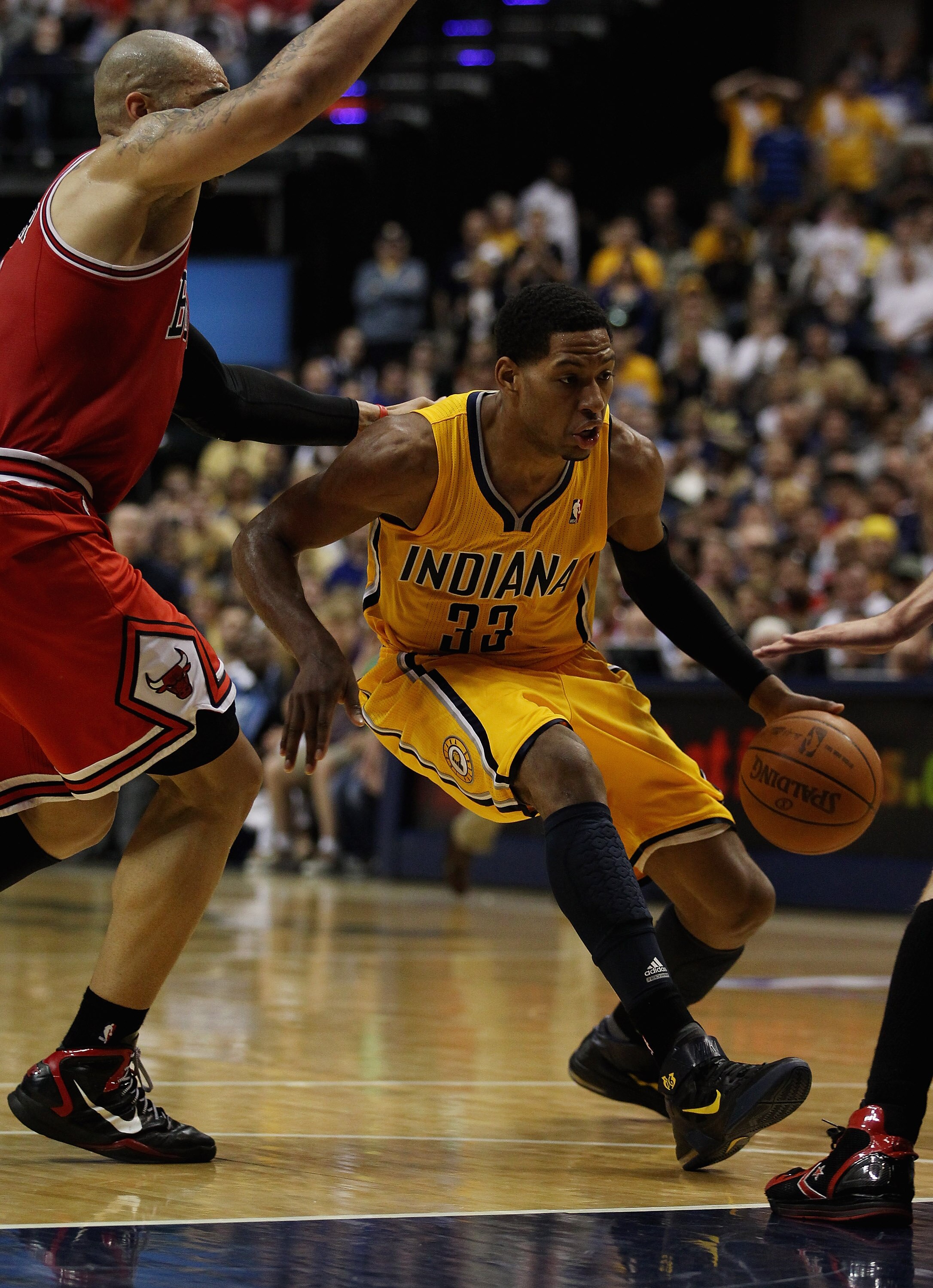 INDIANAPOLIS, IN - APRIL 23: Danny Granger #33 of the Indiana Pacers drives past Carlos Boozer #5 of the Chicago Bulls in Game Four of the Eastern Conference Quarterfinals in the 2011 NBA Playoffs at Conseco Fieldhouse on April 23, 2011 in Indianapolis, I
