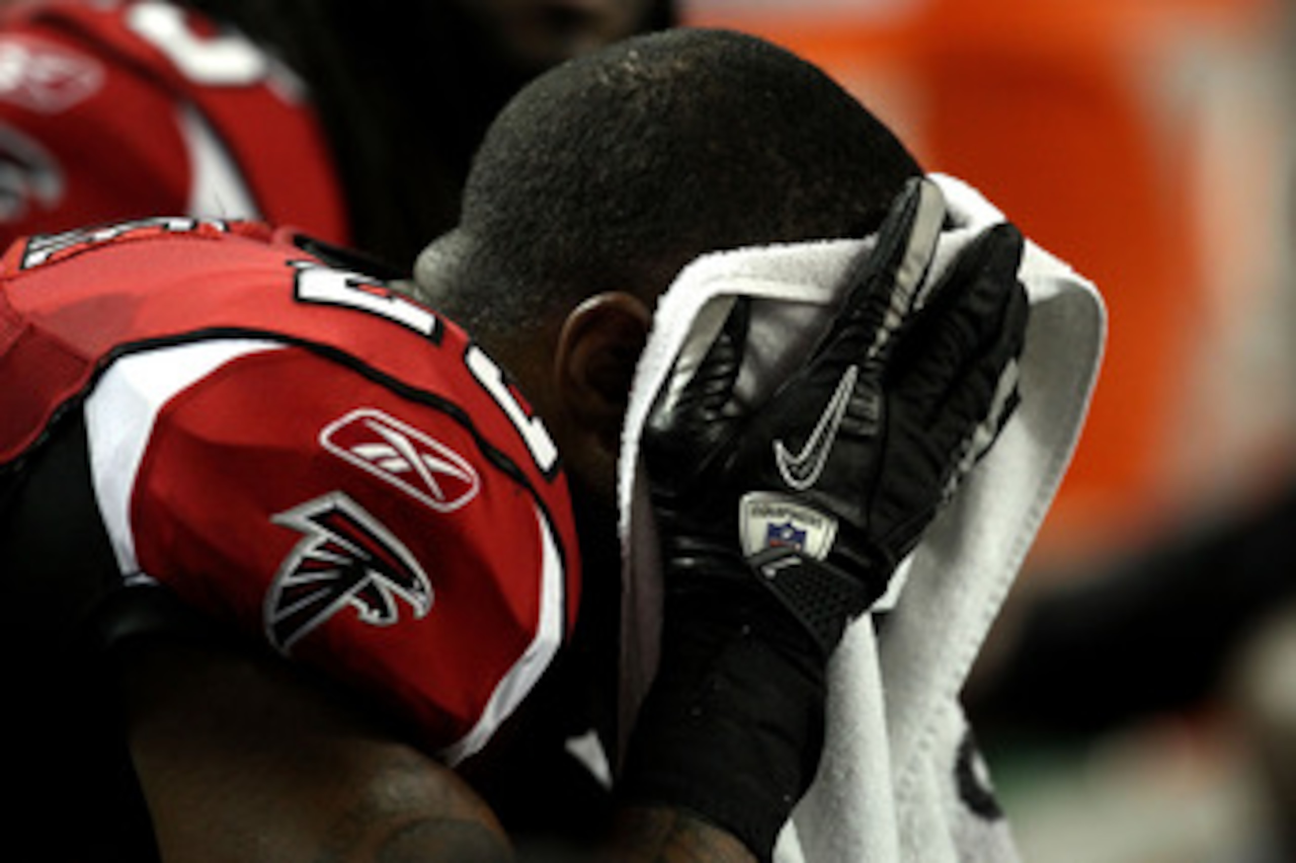 ATLANTA, GA - JANUARY 15:  William Moore #25 of the Atlanta Falcons covers his face with a towel on the bench against the Green Bay Packers during their 2011 NFC divisional playoff game at Georgia Dome on January 15, 2011 in Atlanta, Georgia. The Packers 