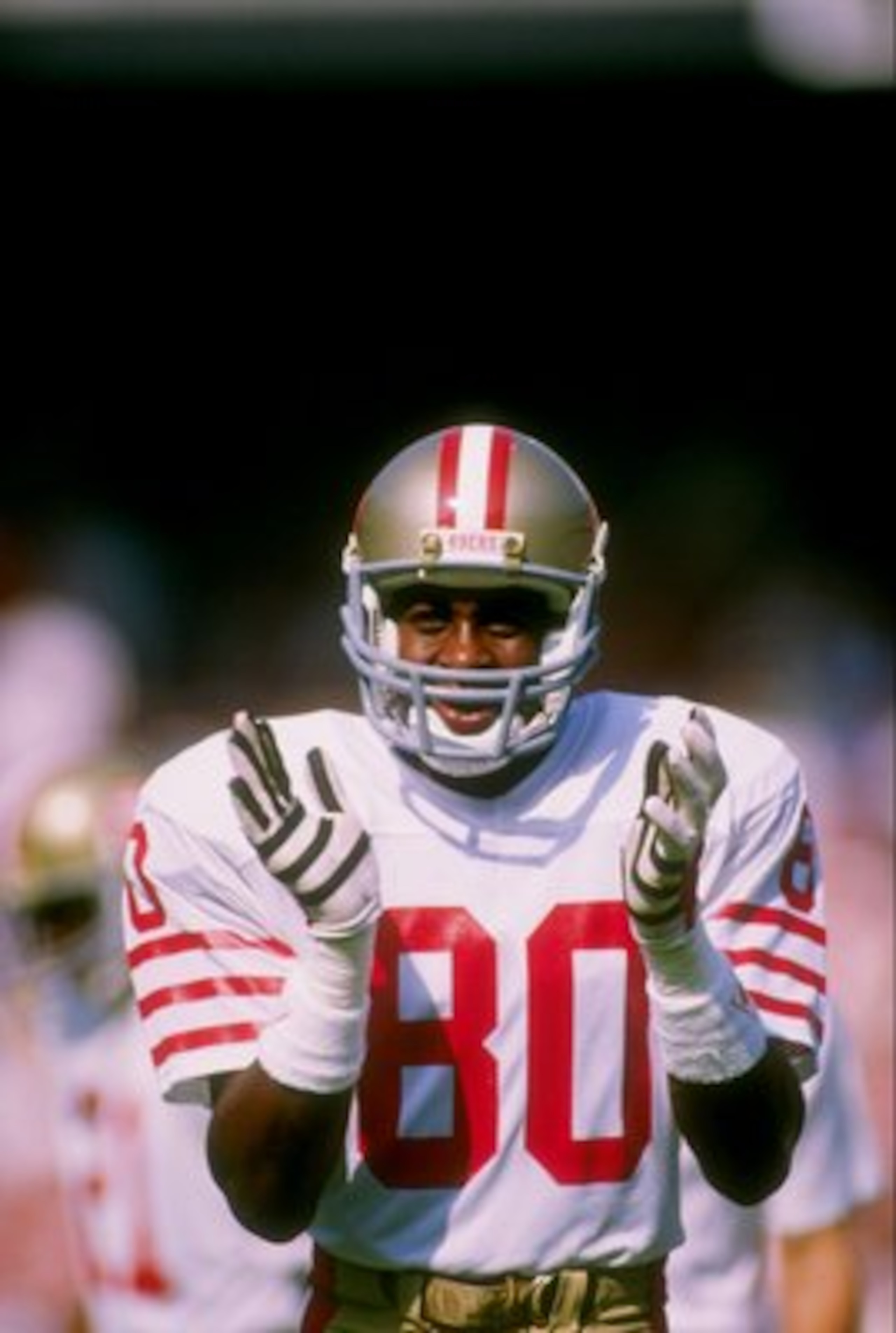27 Oct 1985: Wide receiver Jerry Rice of the San Francisco 49ers claps his hands on the field during a game against the Los Angeles Rams at Anaheim Stadium in Anaheim, California. The 49ers won the game 28-14.