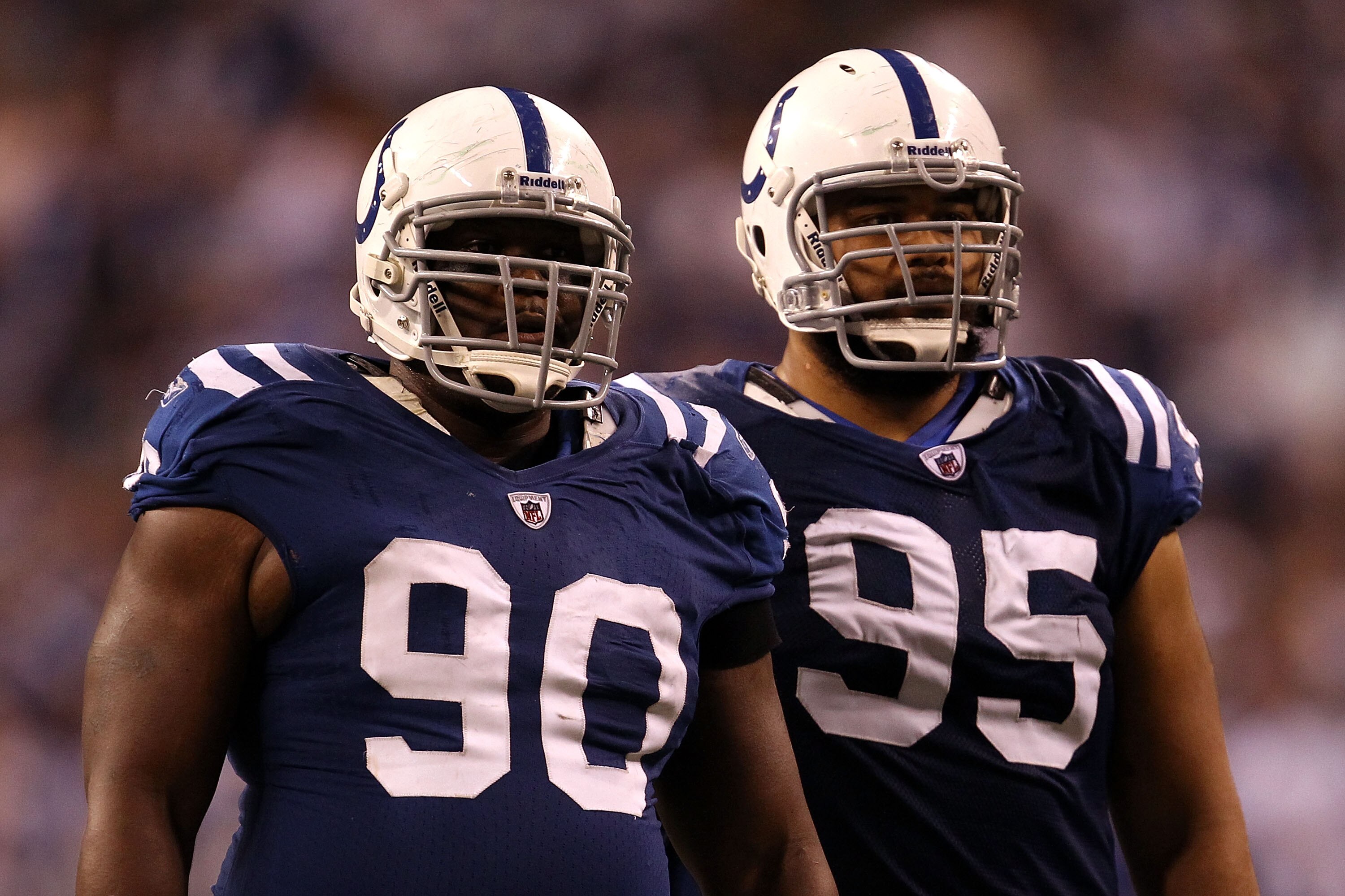 INDIANAPOLIS, IN - JANUARY 08:  (L-R) Dan Muir #90 and Fili Moala #95 of the Indianapolis Colts look on against the New York Jets during their 2011 AFC wild card playoff game at Lucas Oil Stadium on January 8, 2011 in Indianapolis, Indiana. The Jets won 1