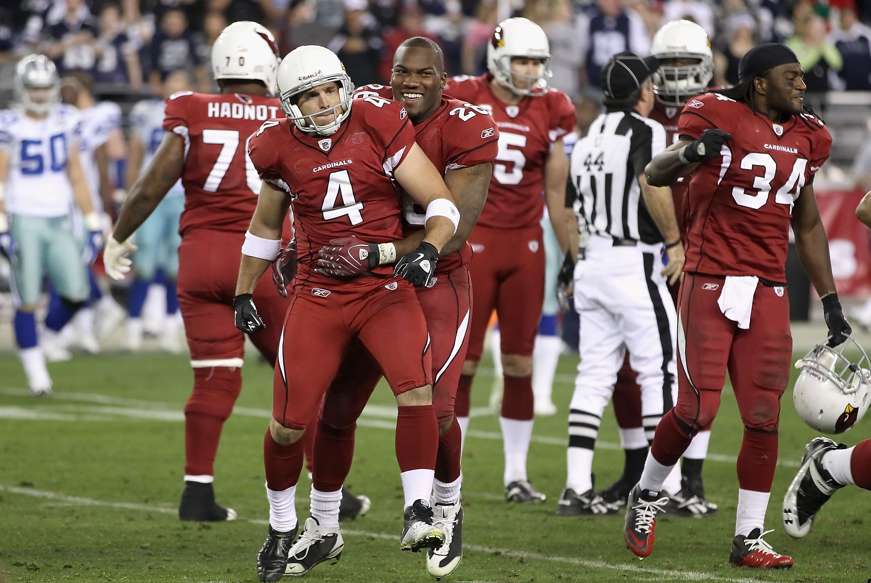 GLENDALE, AZ - DECEMBER 25:  Kicker Jay Feely #4 of the Arizona Cardinals celebrates with Beanie Wells #26 after making a 48 yard field goal in the final moments of the NFL game against the Dallas Cowboys at the University of Phoenix Stadium on December 2