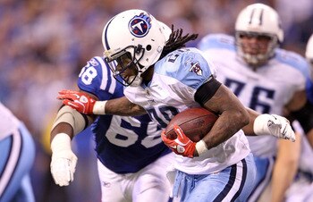 INDIANAPOLIS - JANUARY 02:  Chris Johnson #28 of the Tennessee Titans is tackled by Eric Foster #68 of the Indianapolis Colts at Lucas Oil Stadium on January 2, 2011 in Indianapolis, Indiana.  the Colts won 23-20.  (Photo by Andy Lyons/Getty Images)