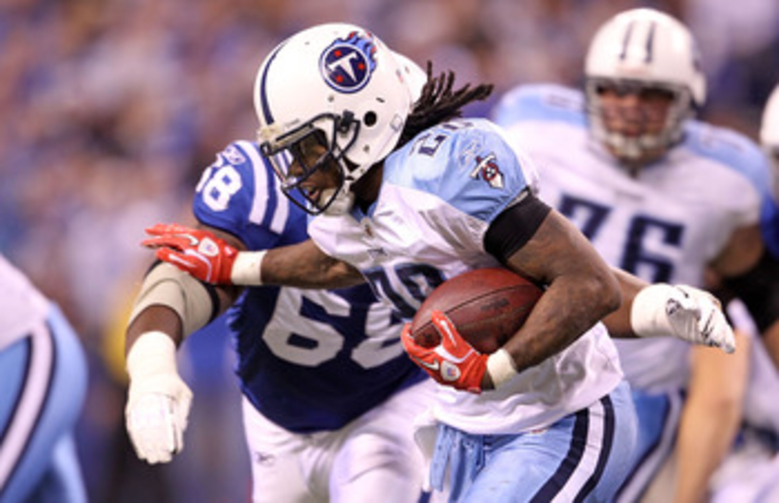INDIANAPOLIS - JANUARY 02:  Chris Johnson #28 of the Tennessee Titans is tackled by Eric Foster #68 of the Indianapolis Colts at Lucas Oil Stadium on January 2, 2011 in Indianapolis, Indiana.  the Colts won 23-20.  (Photo by Andy Lyons/Getty Images)