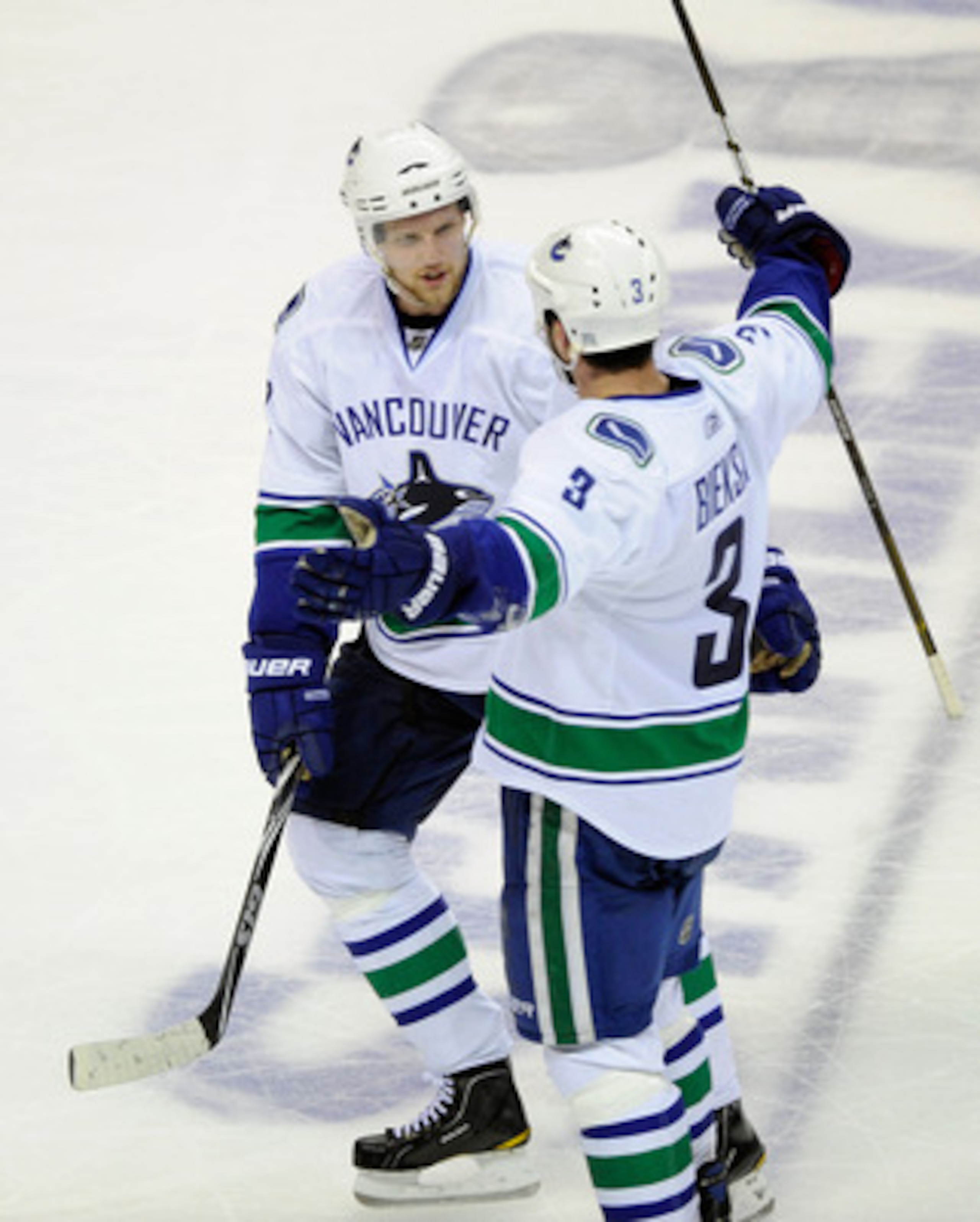 SAN JOSE, CA - MAY 20:  Alexander Edler #23 and Kevin Bieksa #3 of the Vancouver Canucks celebrate Bieksa's third period goal in Game Three of the Western Conference Finals against the San Jose Sharks during the 2011 Stanley Cup Playoffs at HP Pavilion on