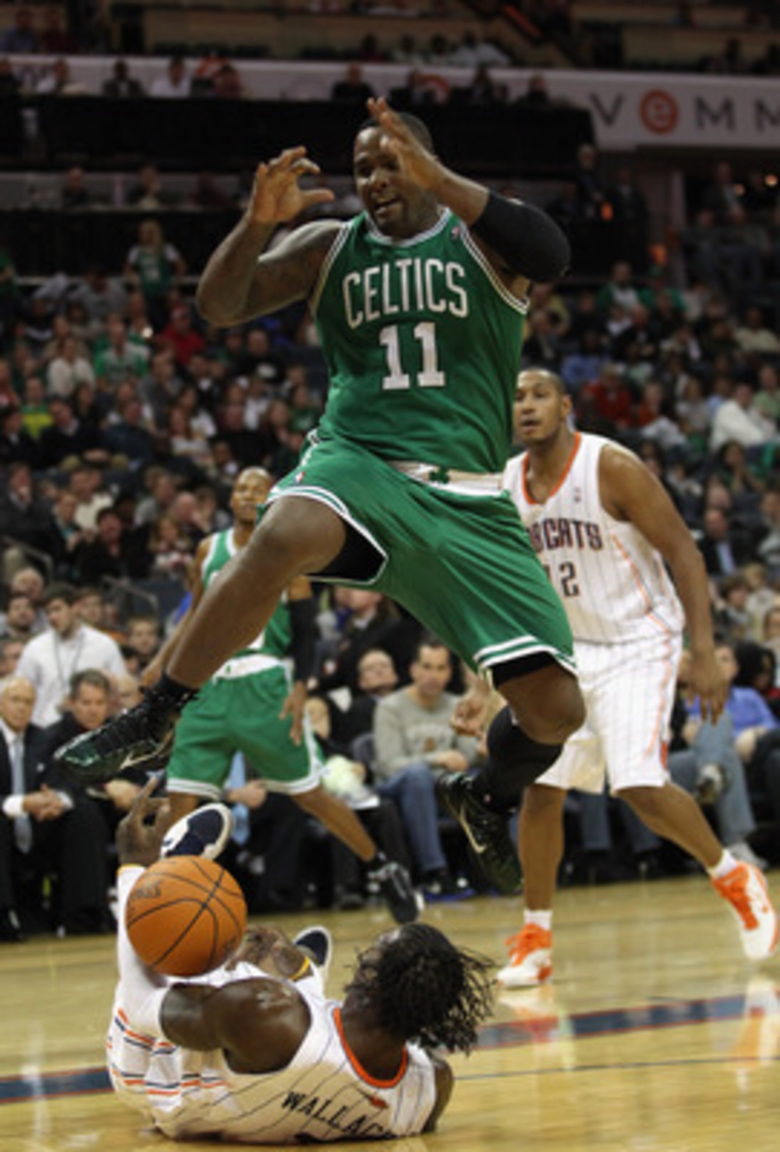 CHARLOTTE, NC - DECEMBER 11:  Glen Davis #11 of the Boston Celtics jumps over Gerald Wallace #3 of the Charlotte Bobcats during their game at Time Warner Cable Arena on December 11, 2010 in Charlotte, North Carolina. NOTE TO USER: User expressly acknowled