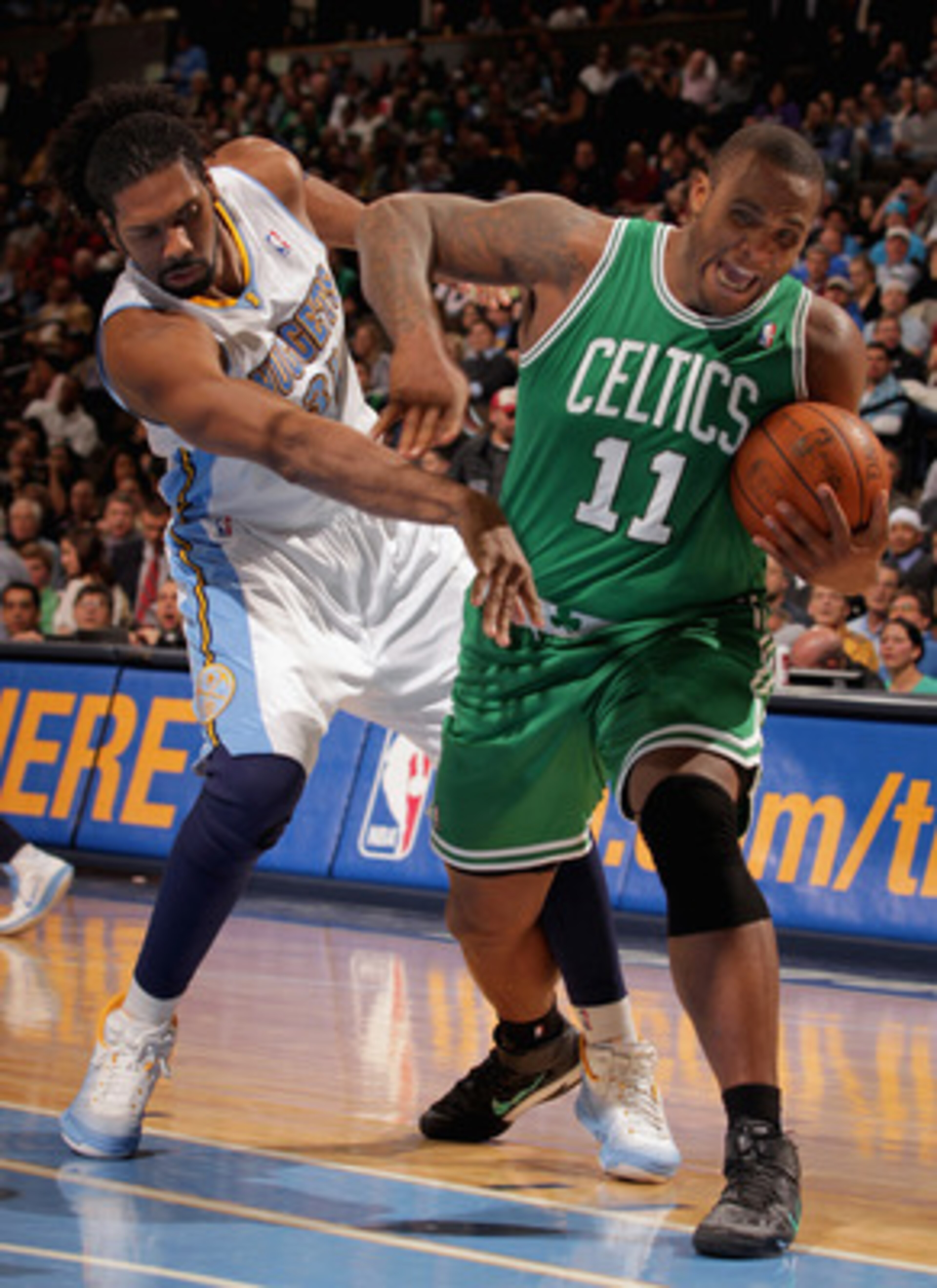 DENVER, CO - FEBRUARY 24: Nene #31 of the Denver Nuggets contests Glen Davis #11 of the Boston Celtics for control of the ball during NBA action at the Pepsi Center on February 24, 2011 in Denver, Colorado. The Nuggets defeated the Celtics 89-75. NOTE TO DENVER, CO - FEBRUARY 24: Nene #31 of the Denver Nuggets contests Glen Davis #11 of the Boston Celtics for control of the ball during NBA action at the Pepsi Center on February 24, 2011 in Denver, Colorado. The Nuggets defeated the Celtics 89-75. NOTE TO