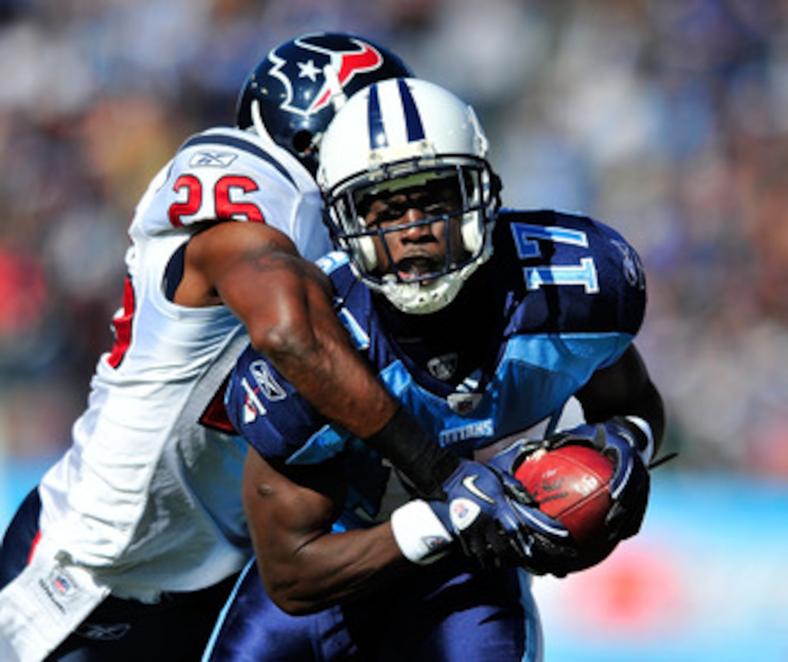 NASHVILLE, TN - DECEMBER 19:  Damian Williams #17 of the Tennessee Titans makes a catch as Eugene Wilson #26 of the Houston Texans defends during the first half at LP Field on December 19, 2010 in Nashville, Tennessee.  (Photo by Grant Halverson/Getty Ima