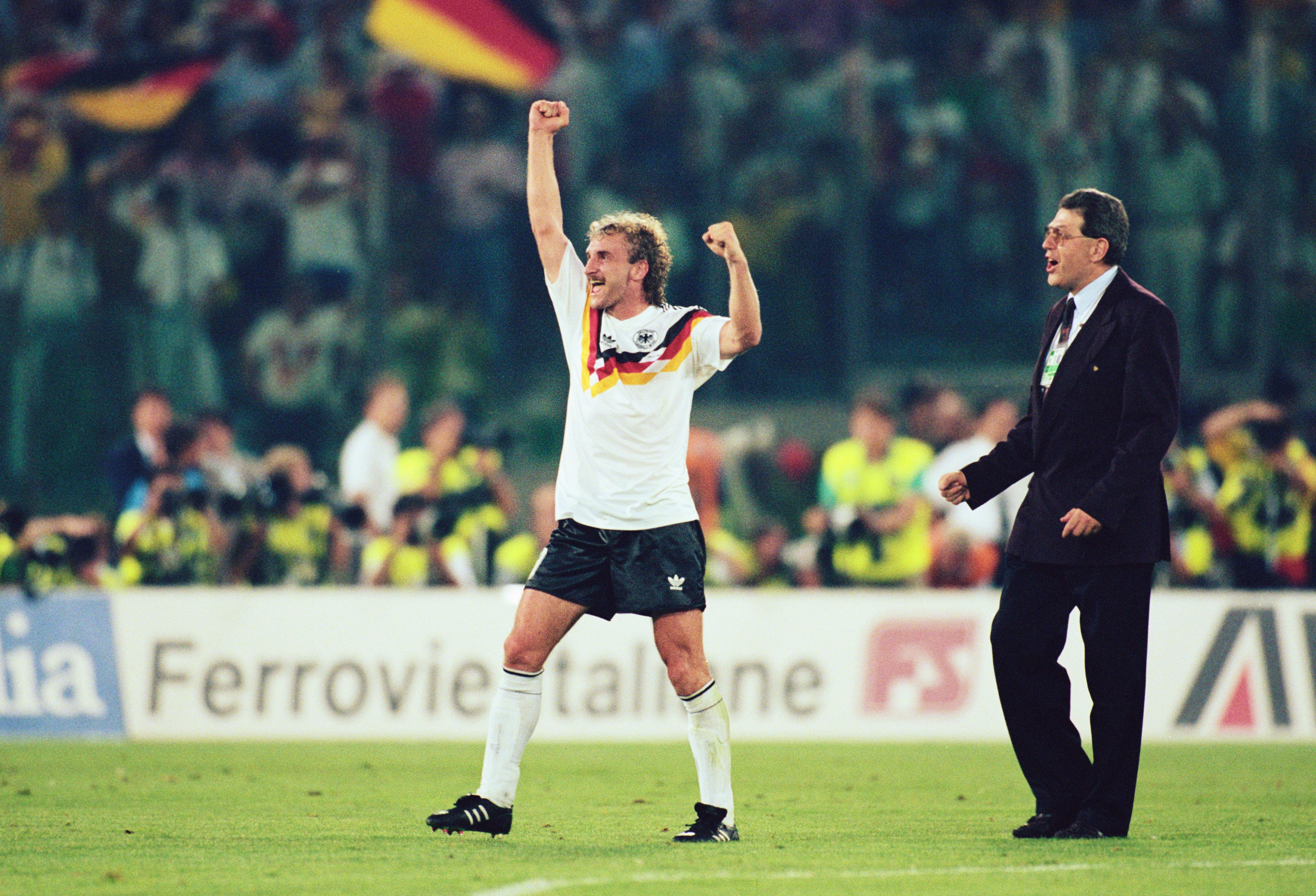 8 JUL 1990:  RUDI VOELLER OF GERMANY WAVES HIS FIST IN CELEBRATION AS GERMAN FLAGS WAVE IN THE CROWD BEHIND HIM AFTER GERMANY WIN THE 1990 SOCCER WORLD CUP FINAL1-0  AGAINST ARGENTINA. Mandatory Credit: Simon Bruty/ALLSPORT