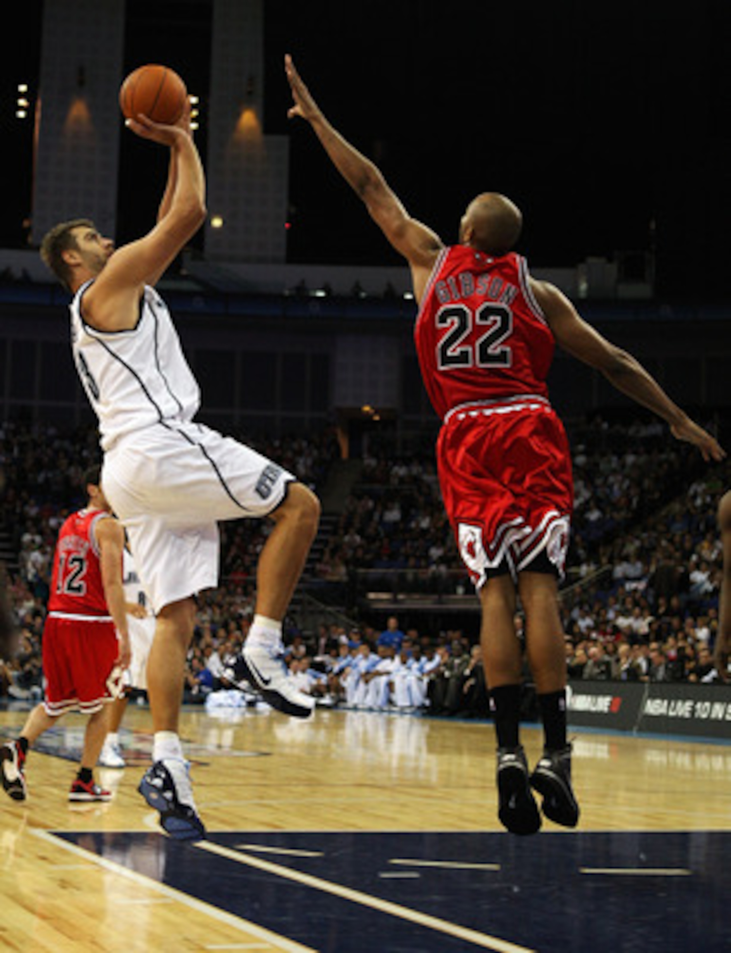LONDON, ENGLAND - OCTOBER 06:  Taj Gibsonn of the Chicago Bulls attempts the block on Mehmet Okur of the Utah Jazz during the NBA pre-season game as part of the 2009 NBA Europe Live Tour between Chicago Bulls and Utah Jazz at the O2 Arena on October 6, 20
