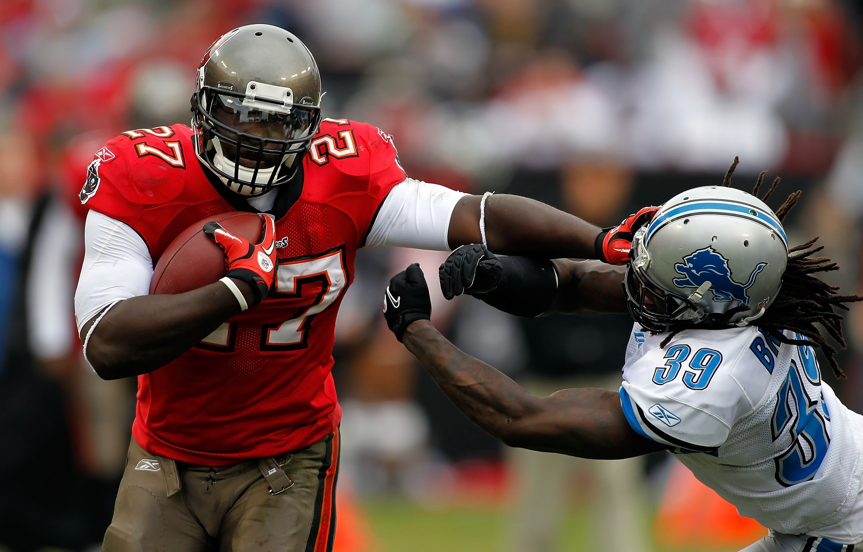 TAMPA, FL - DECEMBER 19:  Running back LeGarrette Blount #27 of the Tampa Bay Buccaneers straight-arms safety C.C. Brown #39 of the Detroit Lions during the game at Raymond James Stadium on December 19, 2010 in Tampa, Florida.  (Photo by J. Meric/Getty Im