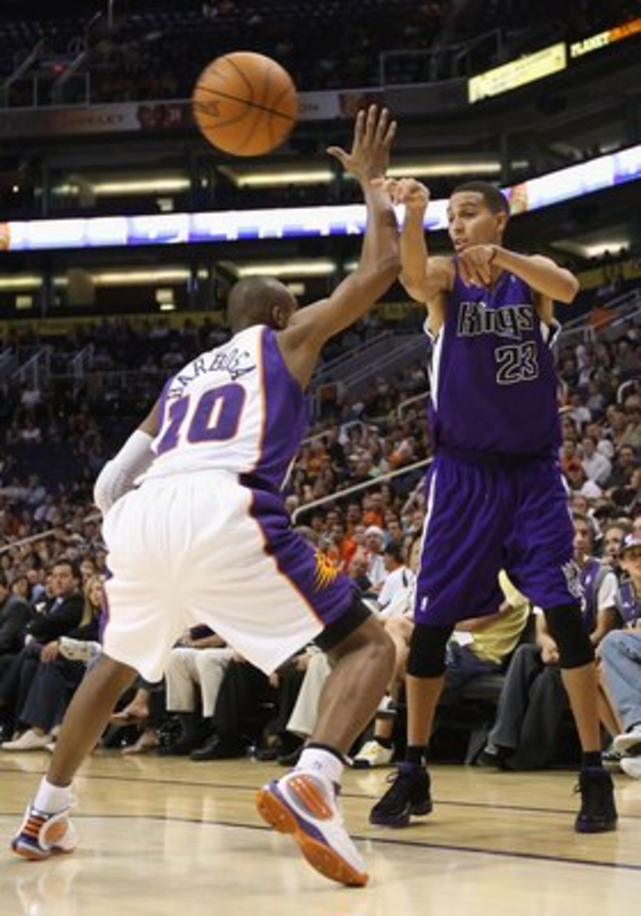 PHOENIX - OCTOBER 20:  Kevin Martin #23 of the Sacramento Kings passes the ball under pressure from the Phoenix Suns during the NBA preseason game at US Airways Center on October 20, 2009 in Phoenix, Arizona. The Suns defeated the Kings 143-127.  NOTE TO 