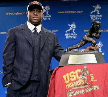 NEW YORK - DECEMBER 10:  Running back Reggie Bush #5 of the USC Trojans poses with the 2005 Heisman trophy after winning the award at the 71st Annual Heisman Ceremony on December 10, 2005 in New York City.  (Photo by Stephen Chernin/Getty Images)