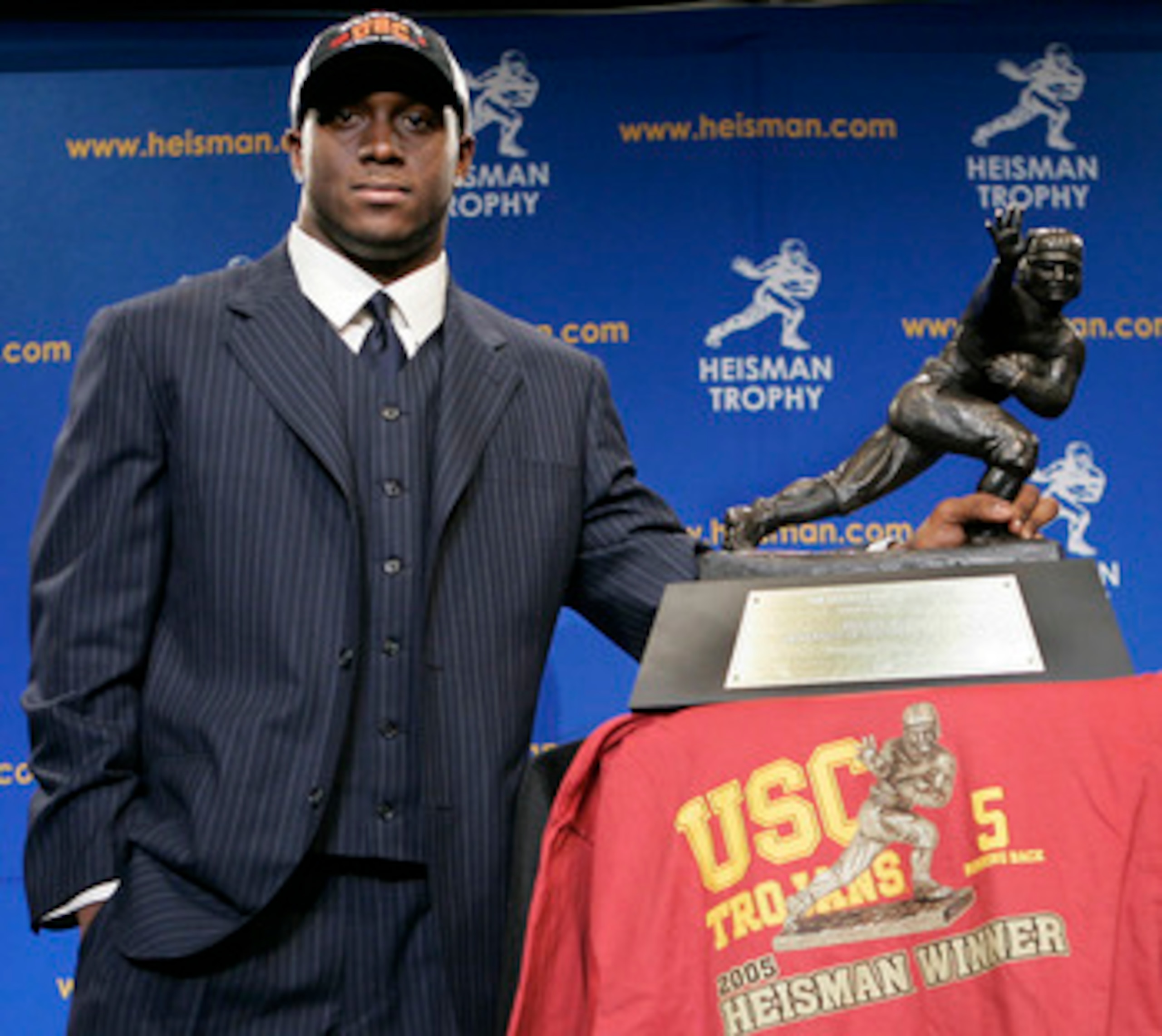 NEW YORK - DECEMBER 10:  Running back Reggie Bush #5 of the USC Trojans poses with the 2005 Heisman trophy after winning the award at the 71st Annual Heisman Ceremony on December 10, 2005 in New York City.  (Photo by Stephen Chernin/Getty Images)