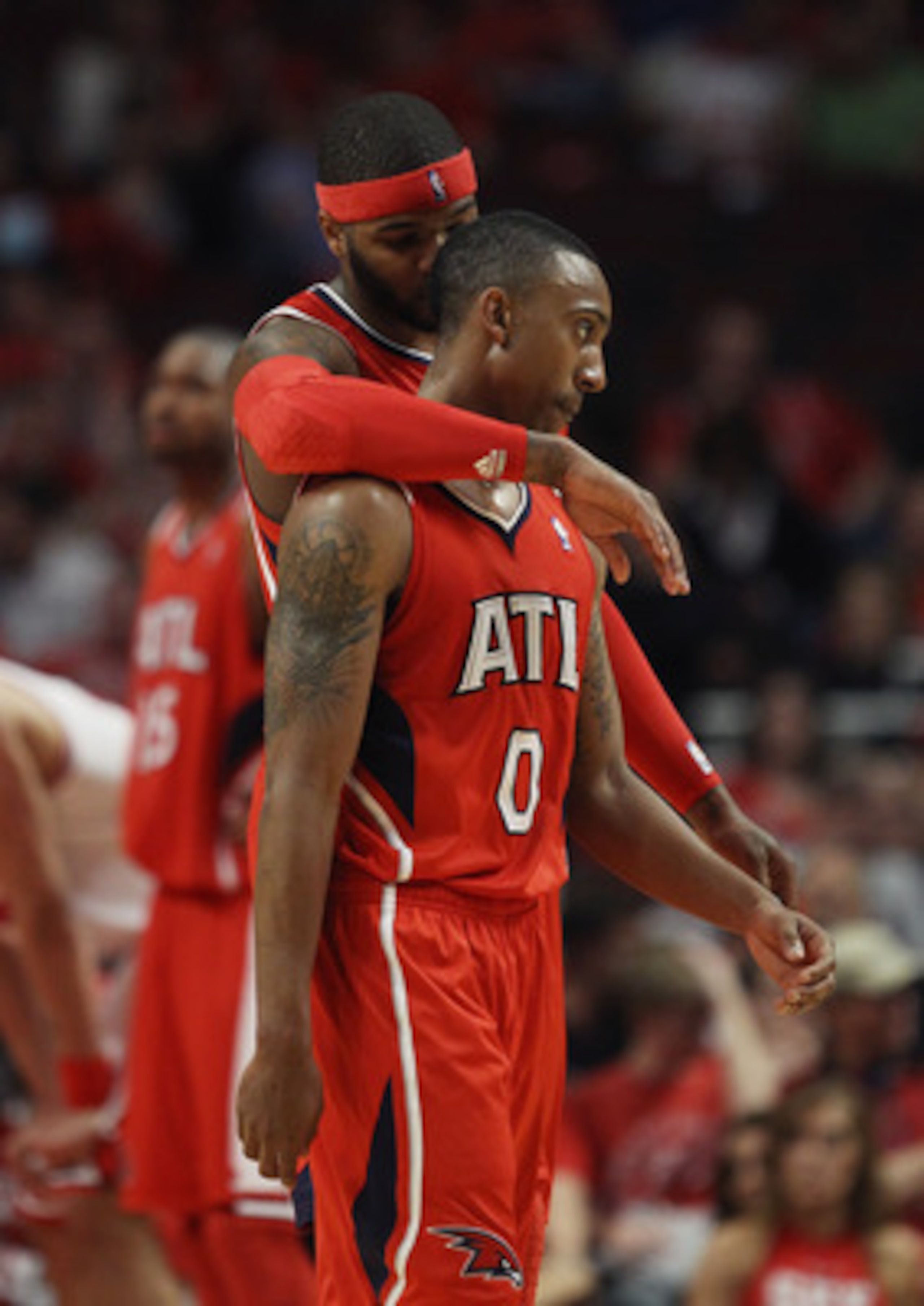 CHICAGO, IL - MAY 02: Josh Smith #5 of the Atlanta Hawks hugs teammate Jeff Teague #0 in the closing minute of a win over the Chicago Bulls in Game One of the Eastern Conference Semifinals in the 2011 NBA Playoffs at the United Center on May 2, 2011 in Ch