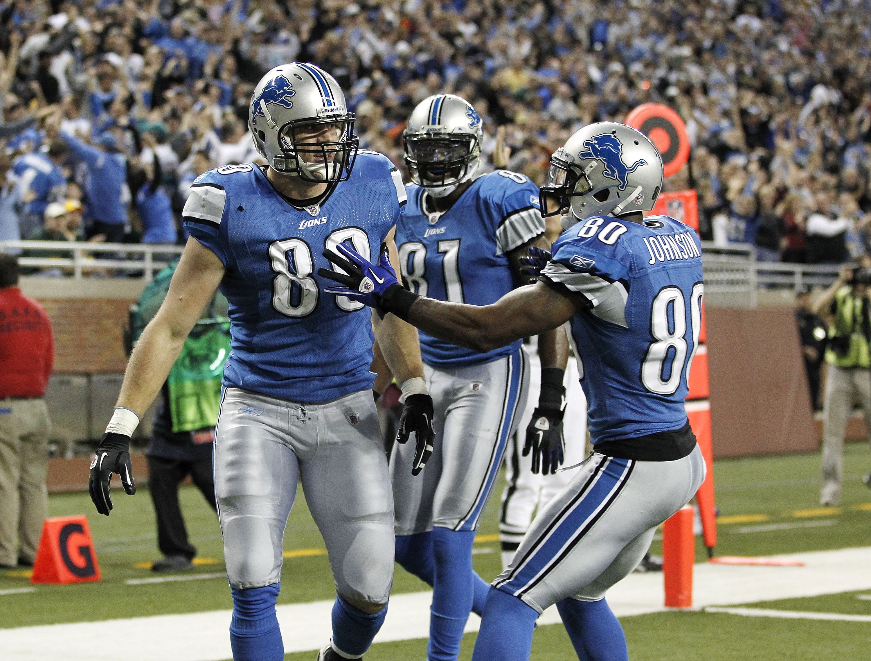 DETROIT, MI - DECEMBER 12:  Will Heller #89 of the Detroit Lions celebrates a for a fourth quarter touchdown with Bryant Johnson #80 and Calvin Johnson #81 while playing the Green Bay Packers on December 12, 2010 at Ford Field in Detroit, Michigan. Detroi