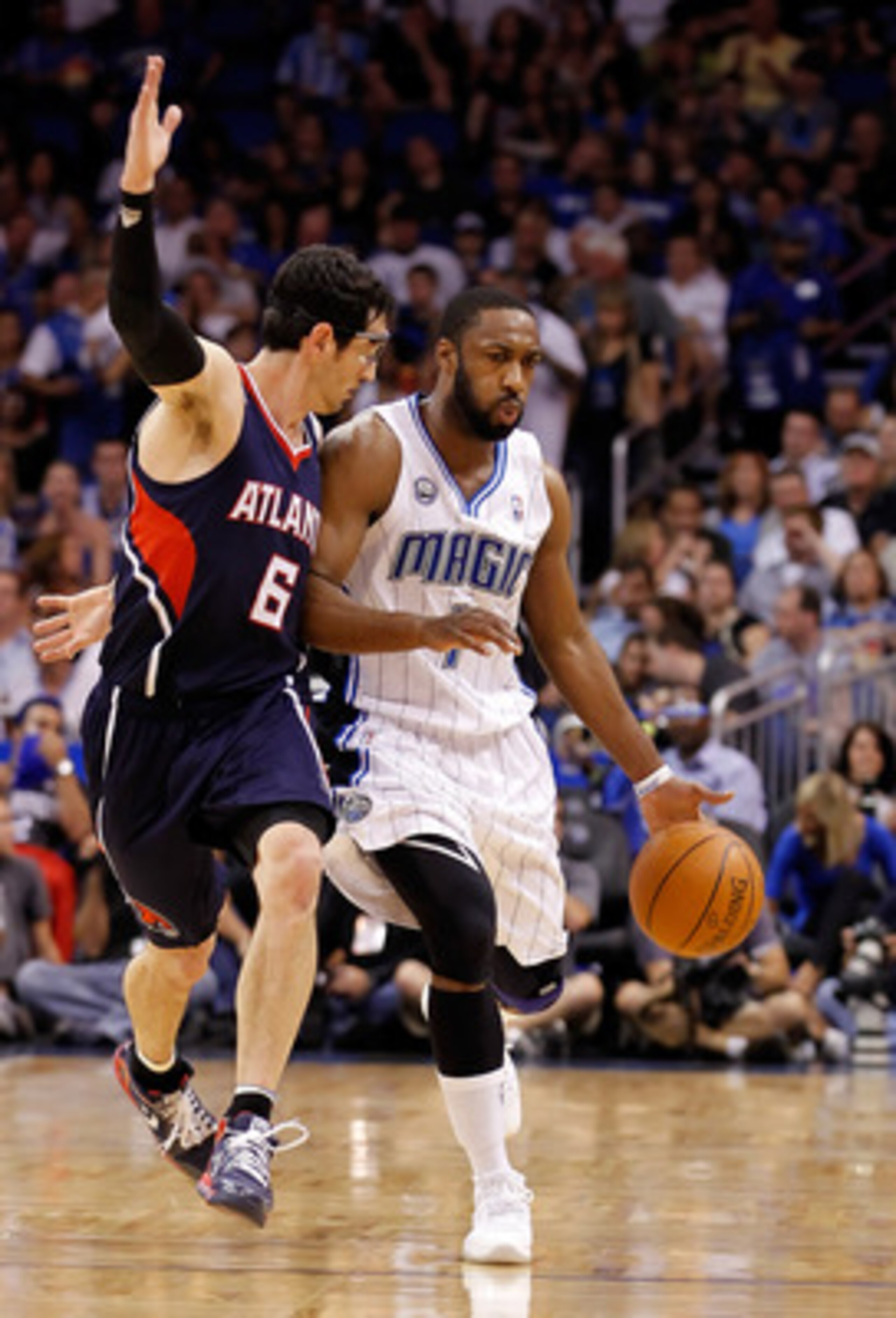 ORLANDO, FL - APRIL 26:  Gilbert Arenas #1 of the Orlando Magic drives past Kirk Hinrich #6 of the Atlanta Hawks during Game Five of the Eastern Conference Quarterfinals of the 2011 NBA Playoffs on April 26, 2011 at the Amway Arena in Orlando, Florida.  N
