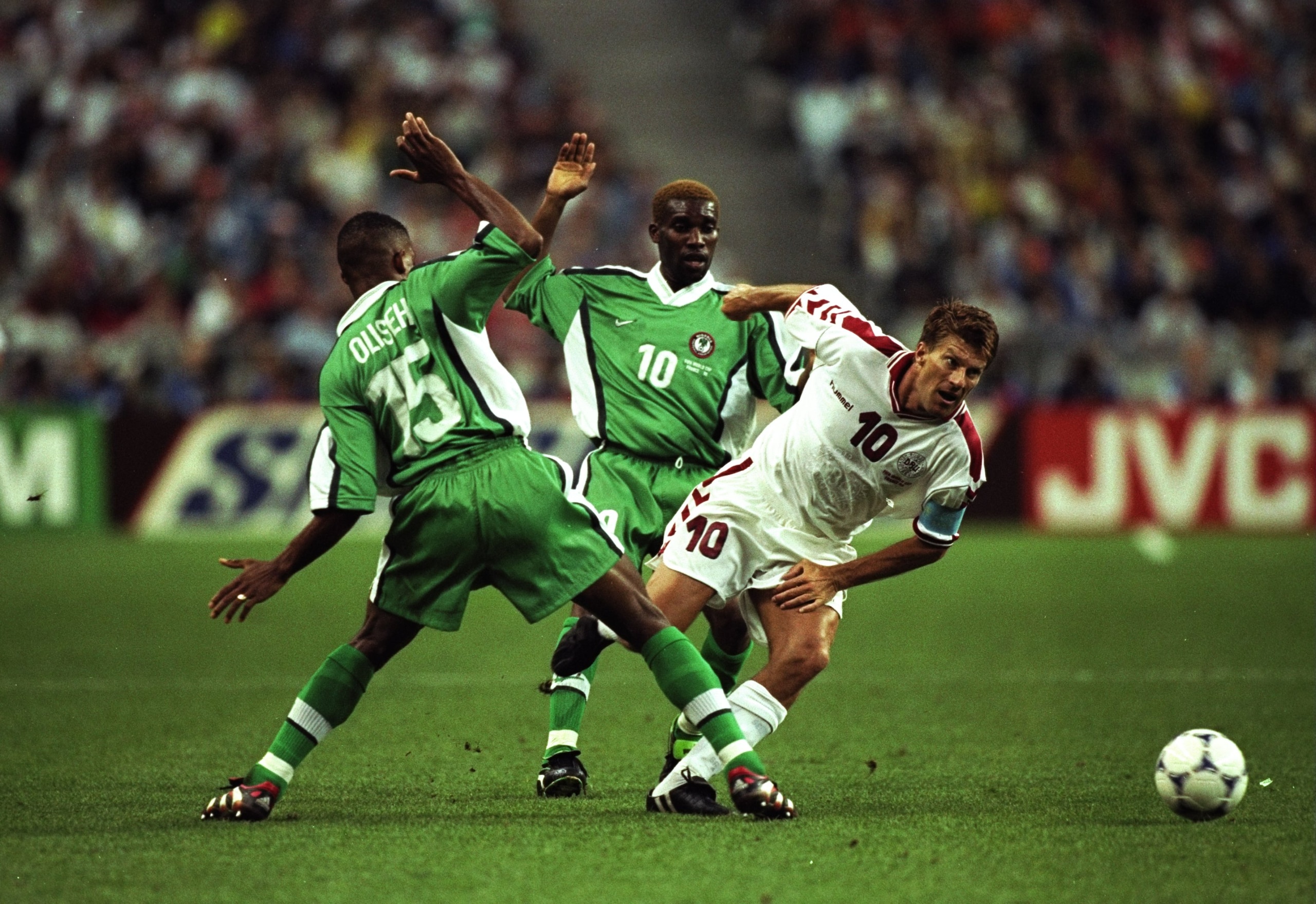 28 Jun 1998:  Denmark captain Michael Laudrup twists past Sunday Oliseh and Jay-Jay Okocha of Nigeria during the World Cup second round match at the Stade de France in St Denis, France. Denmark won 4-1. \ Mandatory Credit: Clive Brunskill /Allsport