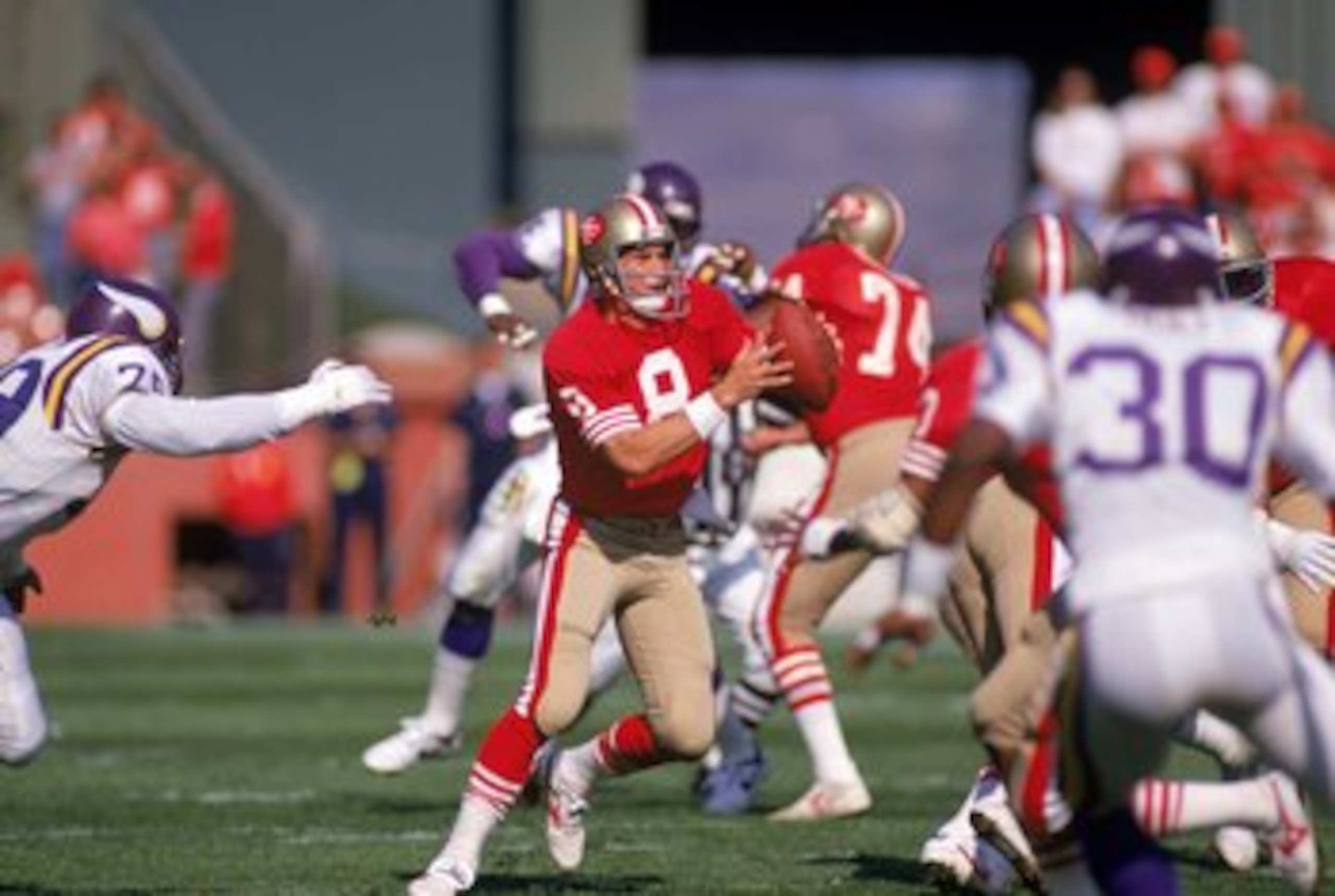 SAN FRANCISCO - OCTOBER 30:  Quarterback Steve Young #8 of the San Francisco 49ers scrambles against the Minnesota Vikings defense during a game at Candlestick Park on October 30, 1988 in San Francisco, California.  The 49ers won 24-21.  (Photo by George