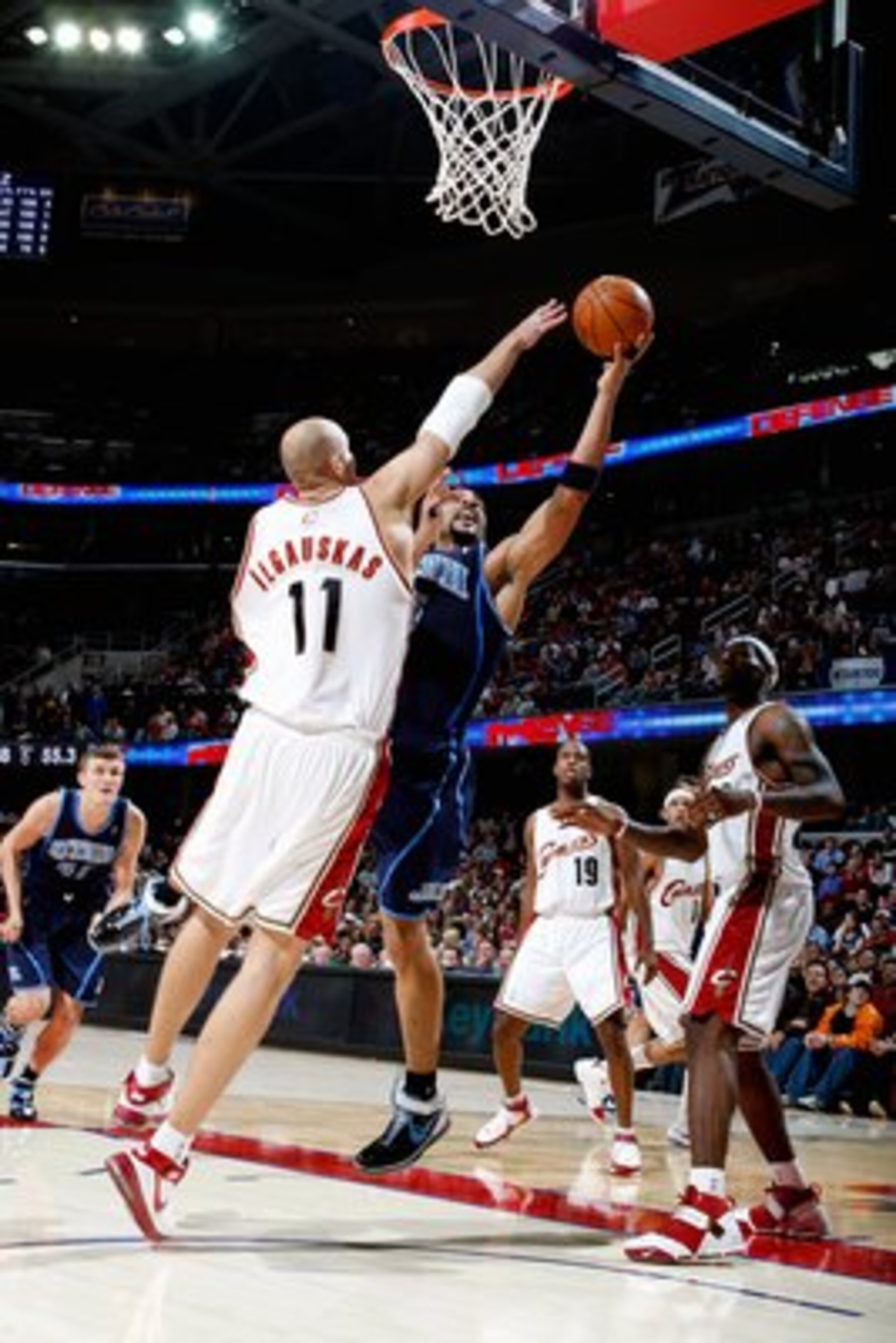 CLEVELAND - NOVEMBER 16: Carlos Boozer #5 of the Utah Jazz lays the ball up against Zydrunas Ilgauskas #11 of the Cleveland Cavaliers during the game on November 16, 2007 at Quicken Loans Arena in Cleveland, Ohio.  The Cavs won 99-94.  NOTE TO USER: User
