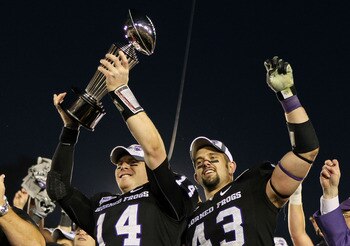 PASADENA, CA - JANUARY 01:  Quarterback Andy Dalton #14 and linebacker Tank Carder #43 of the TCU Horned Frogs celebrate with the Rose Bowl Championship Trophy after defeating the Wisconsin Badgers 21-19 in the 97th Rose Bowl game on January 1, 2011 in Pa
