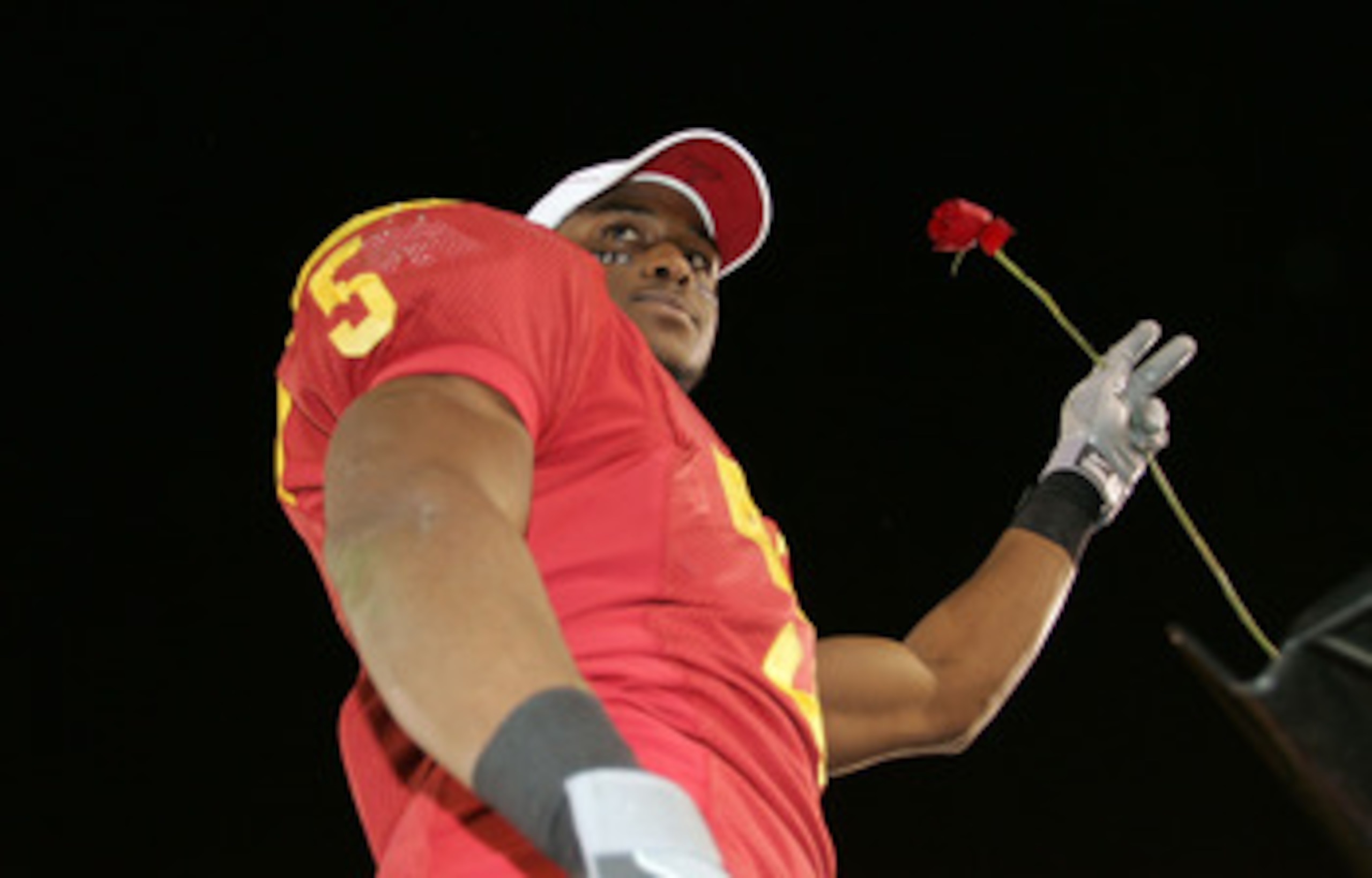 LOS ANGELES, CA - DECEMBER 03:  Reggie Bush #5 of the USC Trojans holds a rose in hopes of playing in the Rose Bowl following USC's 66-19 win against the UCLA Bruins December 3, 2005 at the Los Angeles Memorial Coliseum in Los Angeles, California.  (Photo