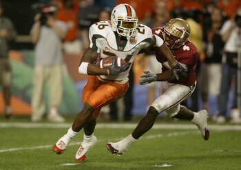 MIAMI - JANUARY 1:  Defensive back Sean Taylor #26 of the Miami Hurricanes attempts to elude wide receiver P.K. Sam #4 of the Florida State Seminoles during the 2004 Orange Bowl game on January 1, 2004 at Pro Player Stadium in Miami, Florida. The Hurrican