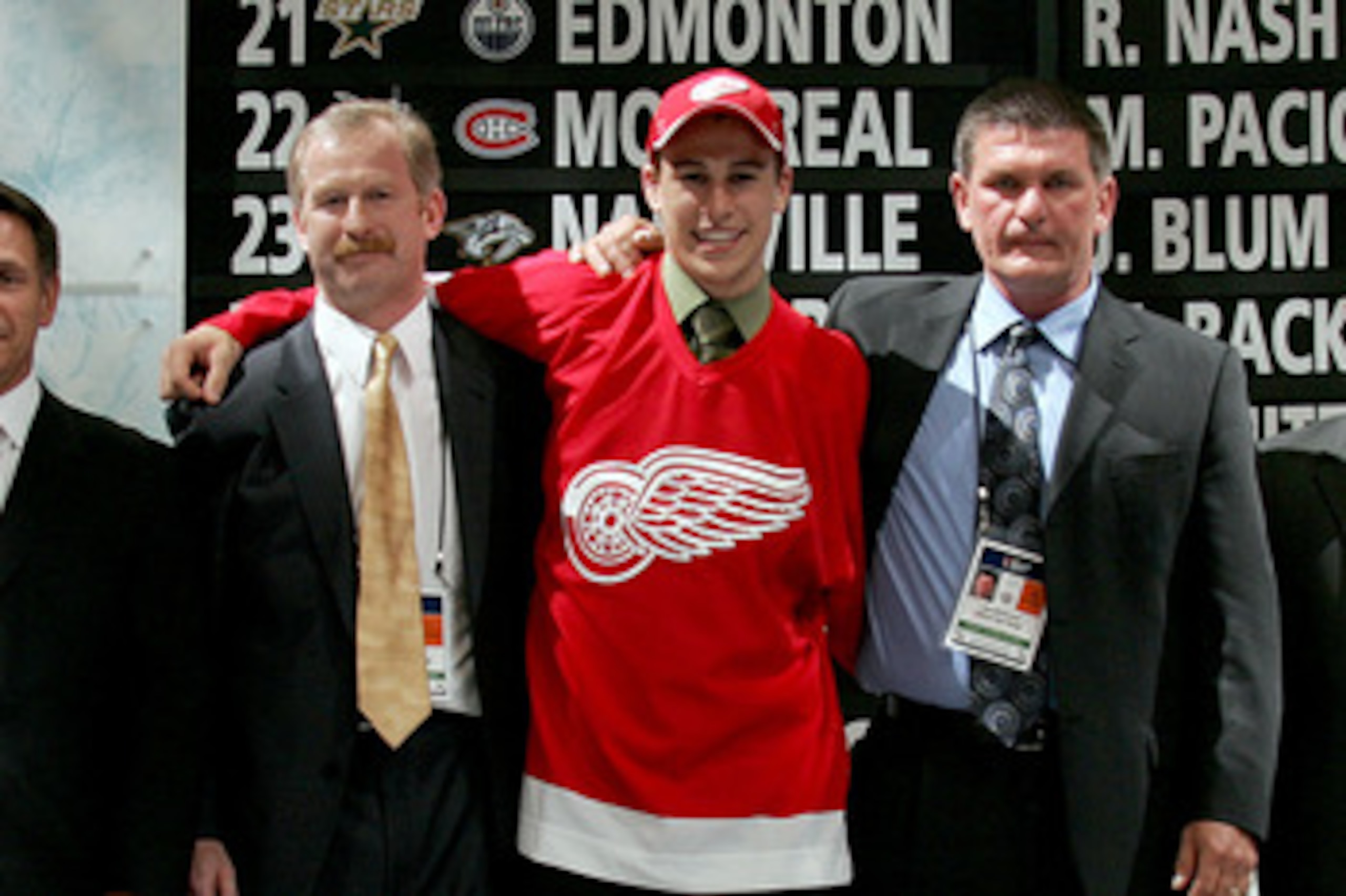 COLUMBUS, OH - JUNE 22:  27th overall pick Brendan Smith of the Detroit Red Wings poses with team personal after being drafted in the first round of the 2007 NHL Entry Draft at Nationwide Arena on June 22, 2007 in Columbus, Ohio.  (Photo by Bruce Bennett/