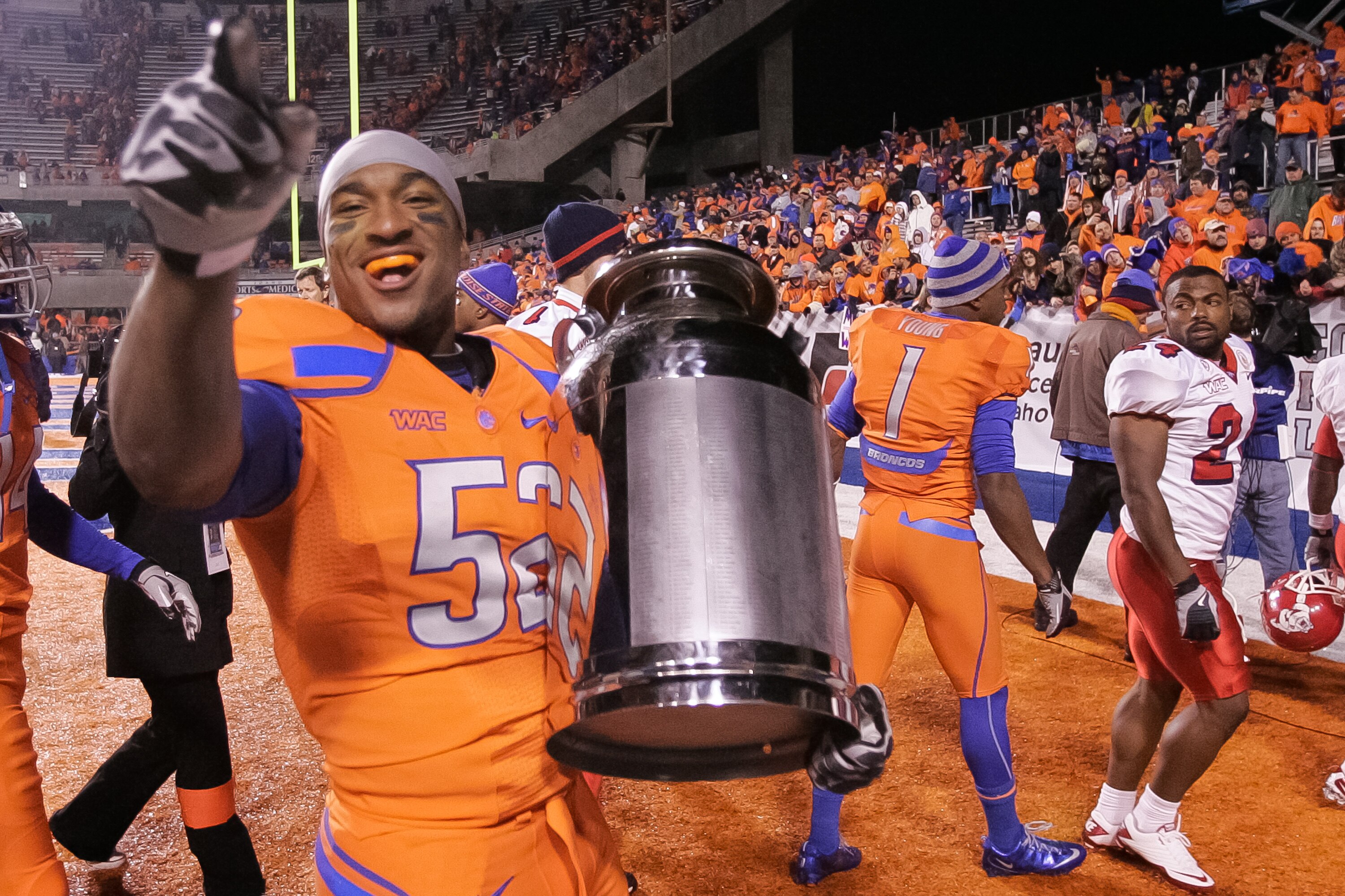 BOISE, ID - NOVEMBER 19:  Derrell Acrey #52 of the Boise State Broncos carries the Milk Can, which is the Boise State - Fresno State rivalry trophy, after the win against the Fresno State Bulldogs at Bronco Stadium on November 19, 2010 in Boise, Idaho.  (