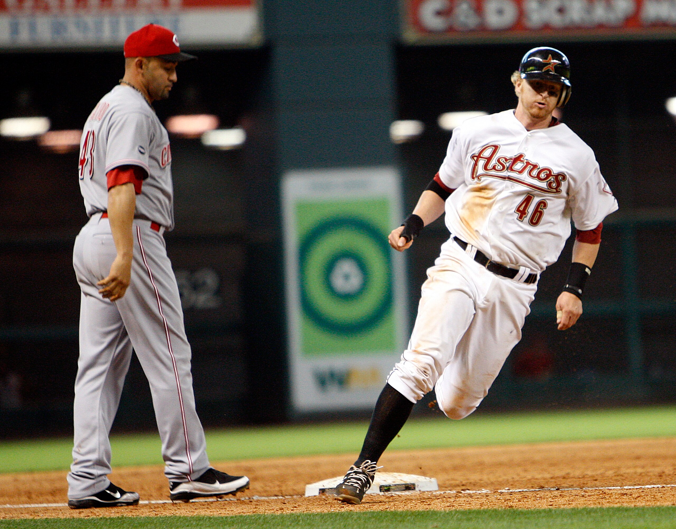 HOUSTON - MAY 11:  J.R. Towles #46 of the Houston Astros rounds third base in front of third baseman Miguel Cairo #43 of the Cincinnati Reds with the winning run after a double by Hunter Pence #9 in the ninth inning at Minute Maid Park on May 11, 2011 in