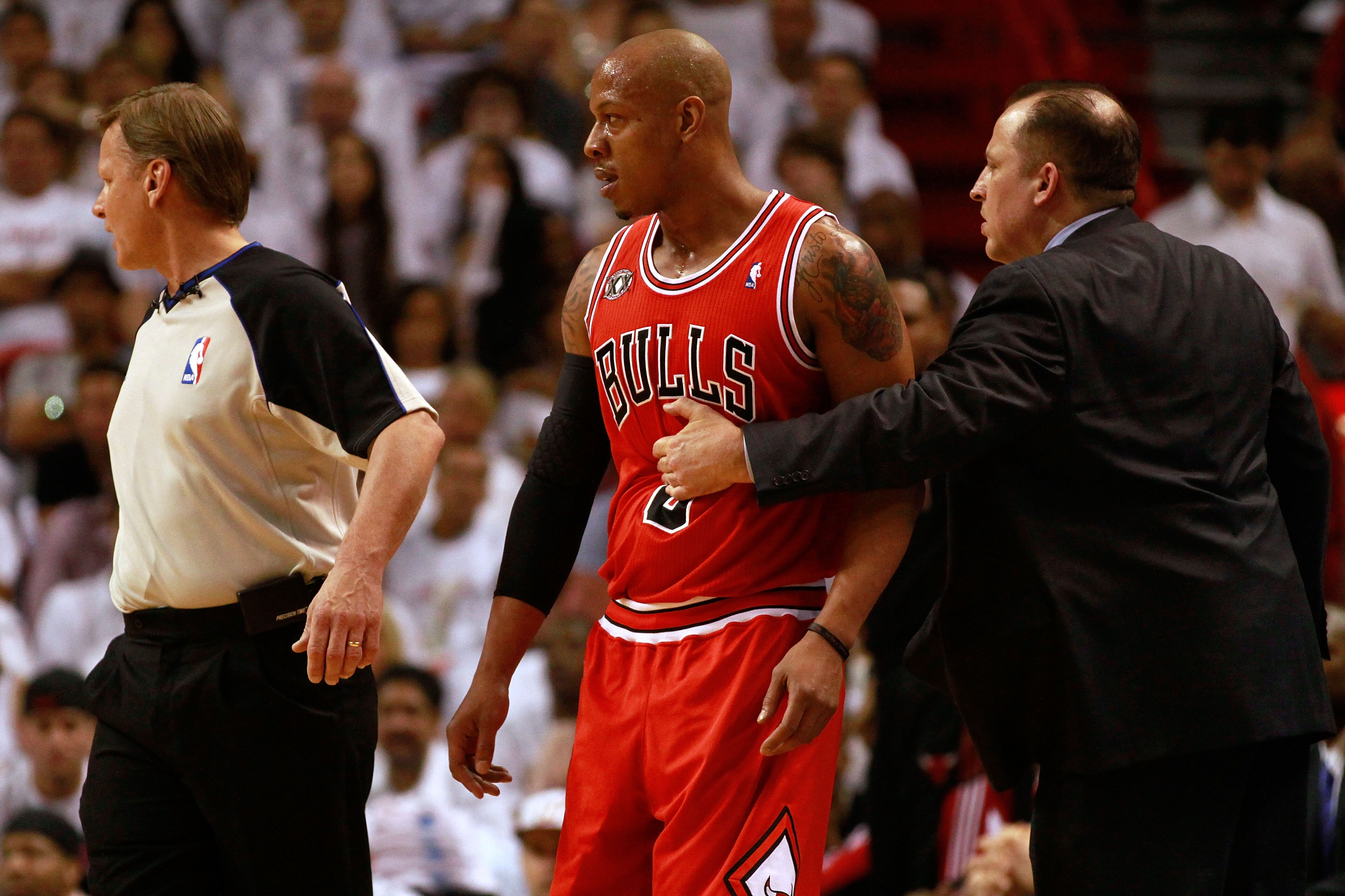 MIAMI, FL - MAY 22: Head coach Tom Thibodeau of the Chicago Bulls holds back Keith Bogans against the Miami Heat in Game Three of the Eastern Conference Finals during the 2011 NBA Playoffs on May 22, 2011 at American Airlines Arena in Miami, Florida. NO MIAMI, FL - MAY 22: Head coach Tom Thibodeau of the Chicago Bulls holds back Keith Bogans against the Miami Heat in Game Three of the Eastern Conference Finals during the 2011 NBA Playoffs on May 22, 2011 at American Airlines Arena in Miami, Florida. NO