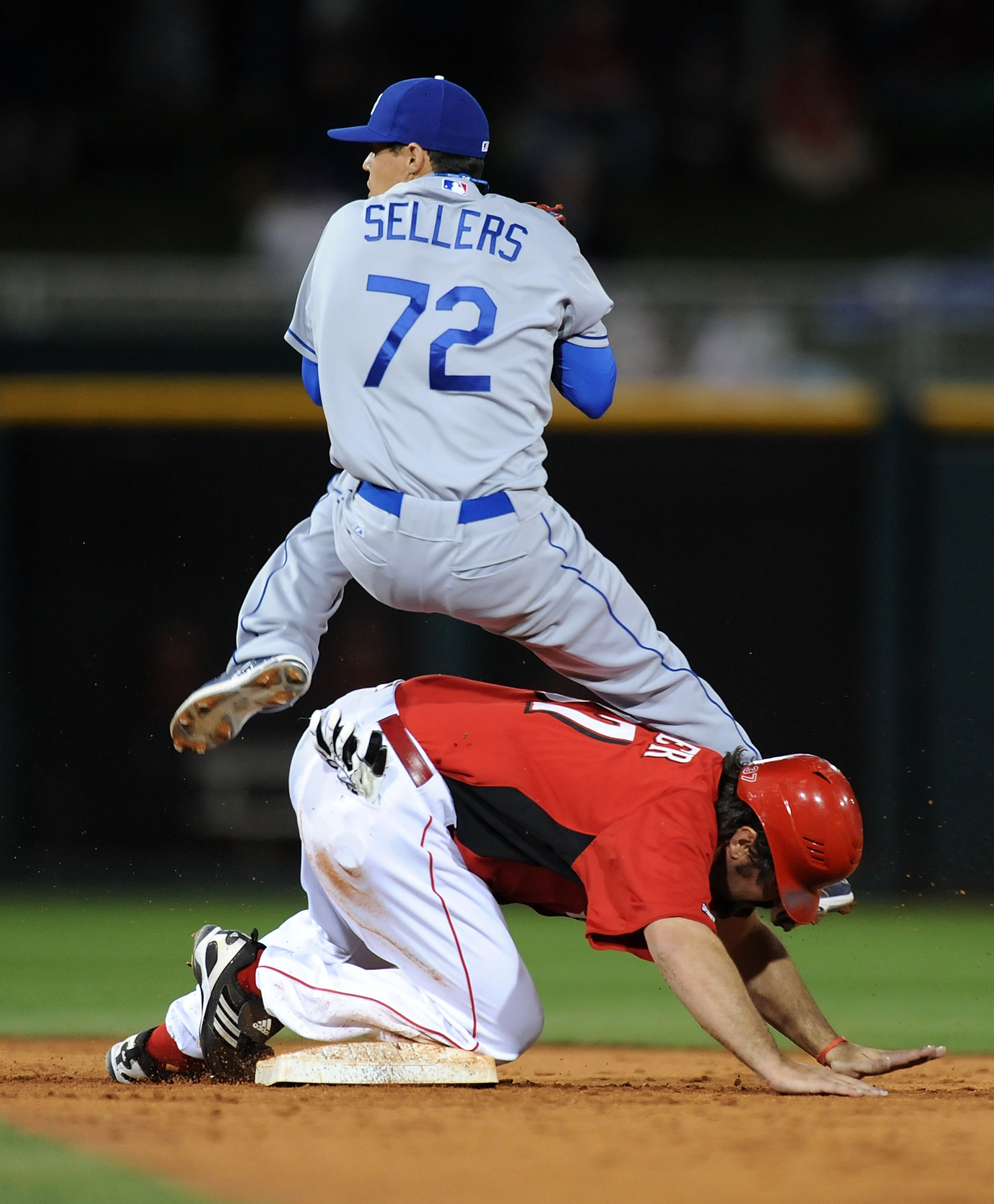 GOODYEAR, AZ - MARCH 03:  Corky Miller #37 of the Cincinnati Reds slides into Justin Sellers #72 of the Los Angeles Dodgers while breaking up a double play attempt at Goodyear Ballpark on March 3, 2011 in Goodyear, Arizona.  (Photo by Norm Hall/Getty Imag