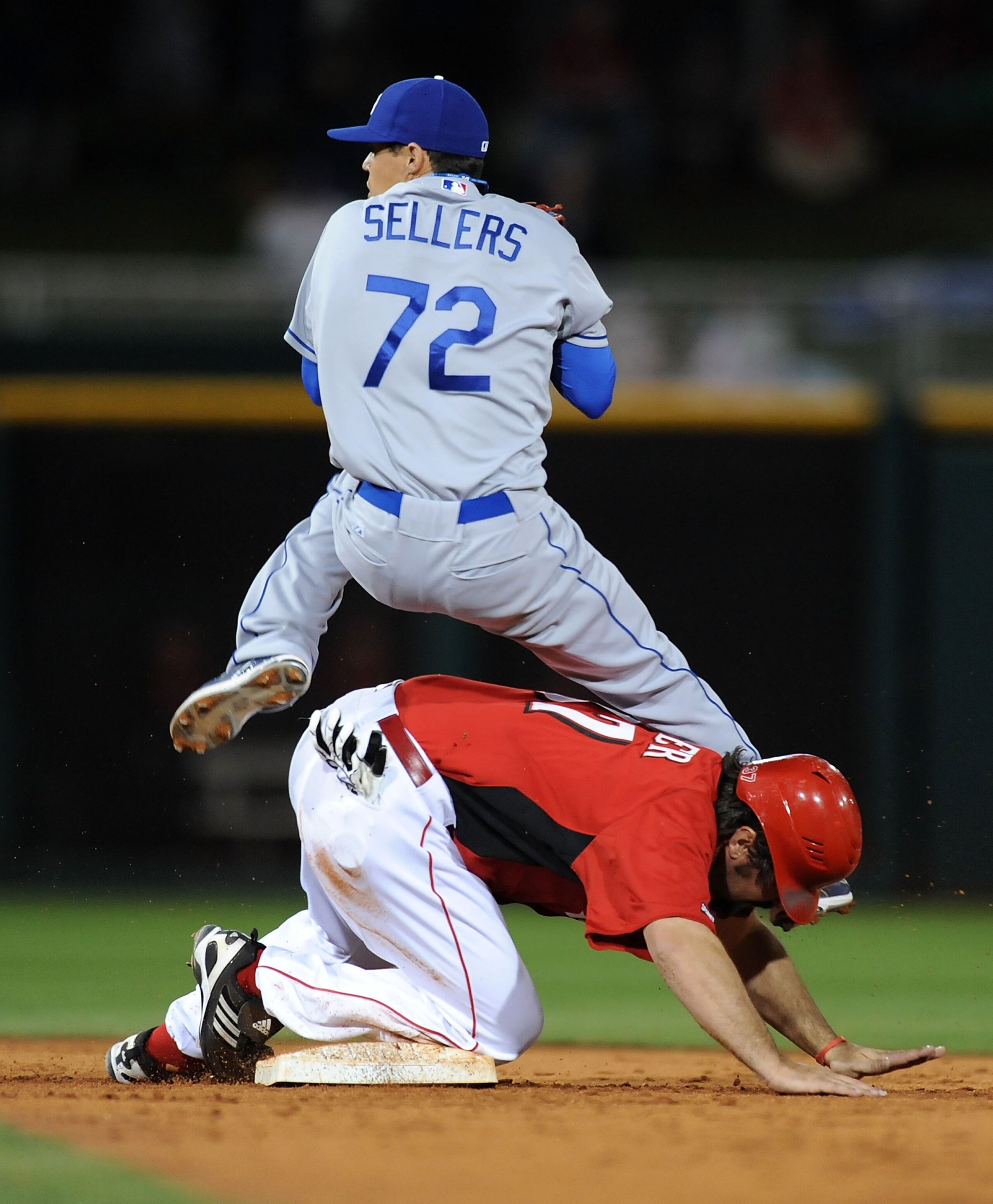 GOODYEAR, AZ - MARCH 03:  Corky Miller #37 of the Cincinnati Reds slides into Justin Sellers #72 of the Los Angeles Dodgers while breaking up a double play attempt at Goodyear Ballpark on March 3, 2011 in Goodyear, Arizona.  (Photo by Norm Hall/Getty Imag