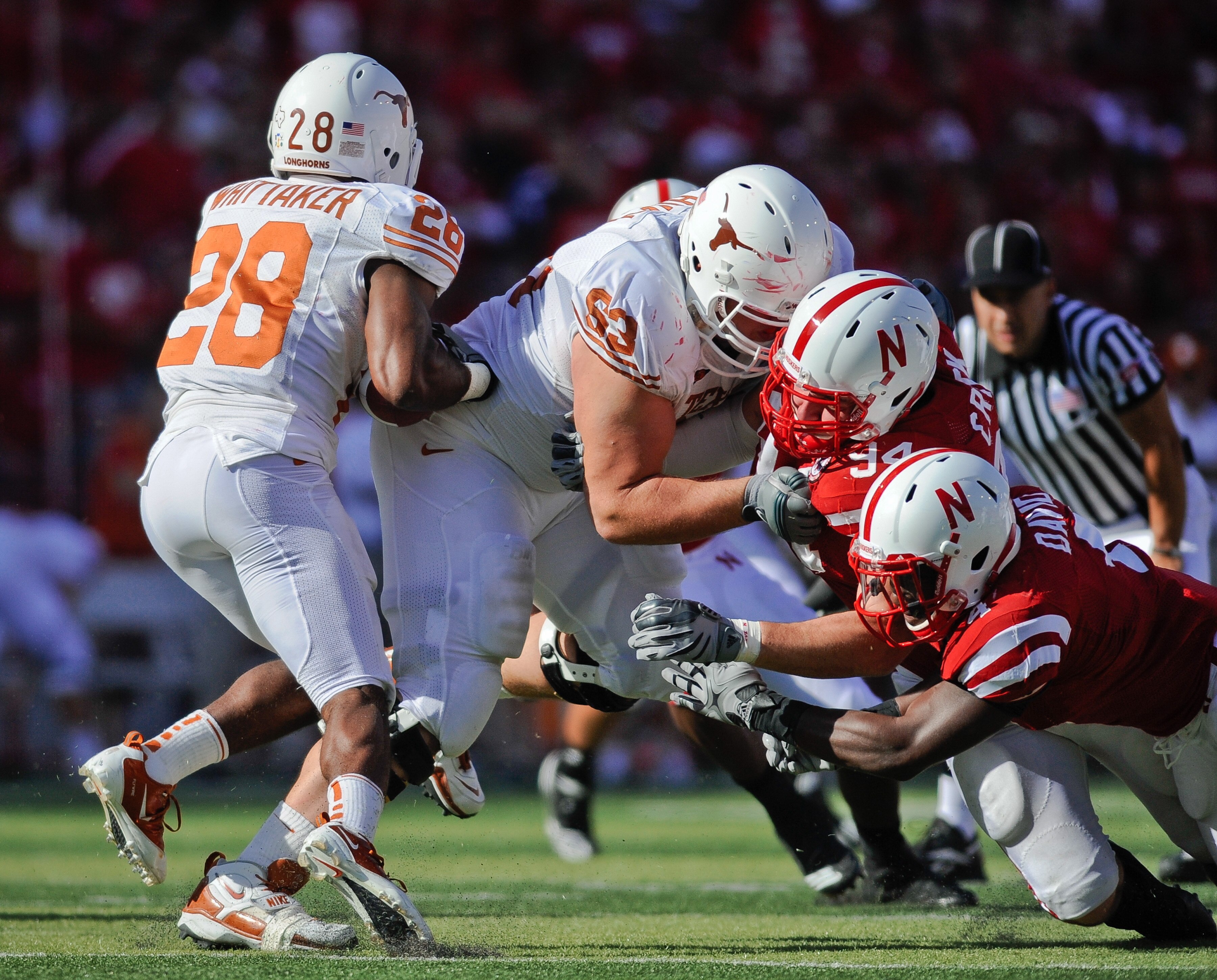 LINCOLN, NE - OCTOBER 16: Linebacker Lavonte David #4 and defensive tackle Jared Crick #94 of the Nebraska Cornhuskers attempt to get their hands on running back Foswhitt Whittaker #28 of the Texas Longhorns during first half action of their game at Memor