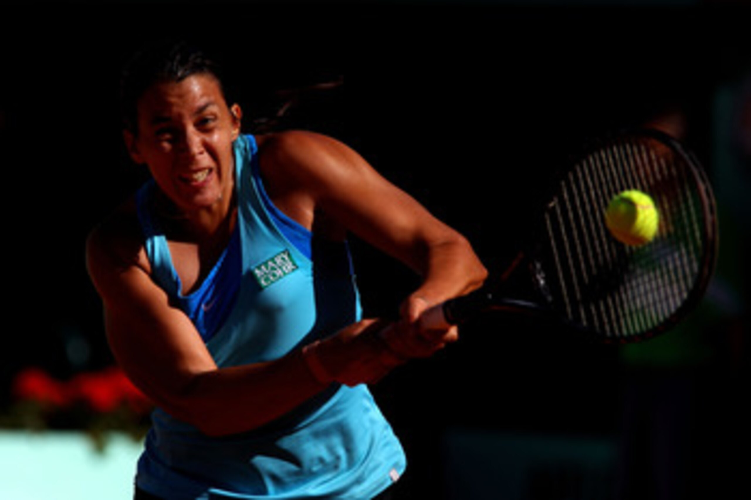 PARIS, FRANCE - MAY 23:  Marion Bartoli of France hits a backhand during the women's singles round one match between Marion Bartoli of France and Anna Tatishvili of Georgia on day two of the French Open at Roland Garros on May 23, 2011 in Paris, France.  