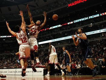 CHICAGO - MARCH 09: Deron Williams #8 of the Utah Jazz passes the ball to teammate Mehmet Okur #13 between Kirk Hinrich #12 and Taj Gibson #22 of the Chicago Bulls at the United Center on March 9, 2010 in Chicago, Illinois. NOTE TO USER: User expressly ac