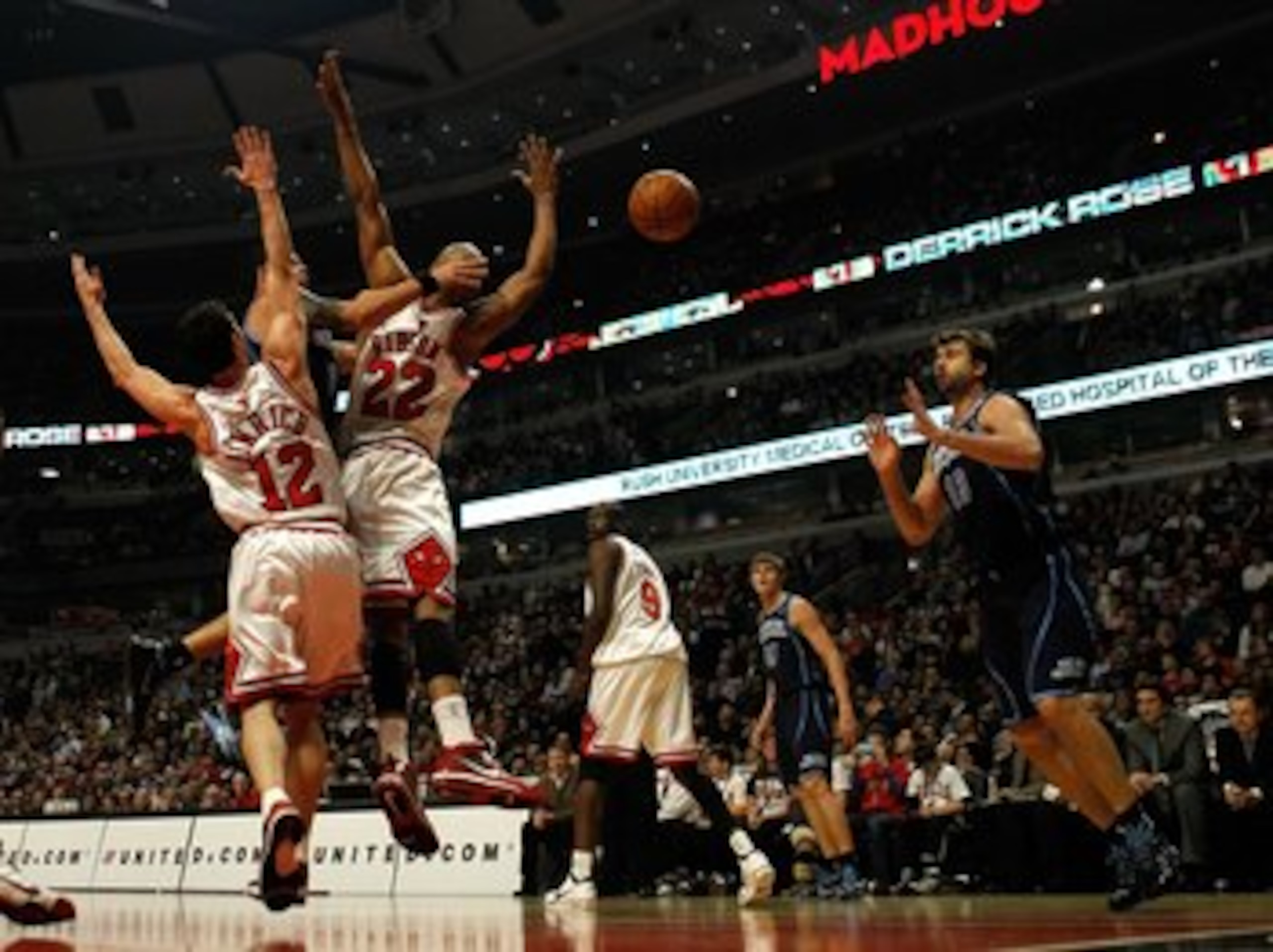 CHICAGO - MARCH 09: Deron Williams #8 of the Utah Jazz passes the ball to teammate Mehmet Okur #13 between Kirk Hinrich #12 and Taj Gibson #22 of the Chicago Bulls at the United Center on March 9, 2010 in Chicago, Illinois. NOTE TO USER: User expressly ac