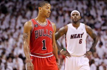 MIAMI, FL - MAY 22:  Derrick Rose #1 of the Chicago Bulls looks on as LeBron James #6 of the Miami Heat stands in the background in Game Three of the Eastern Conference Finals during the 2011 NBA Playoffs on May 22, 2011 at American Airlines Arena in Miam