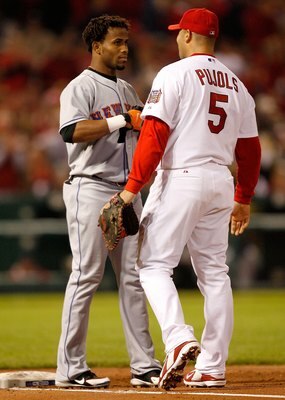 ST LOUIS - OCTOBER 15:  Albert Pujols #5 of the St. Louis Cardinals talks with Jose Reyes #7 of the New York Mets during game four of the NLCS at Busch Stadium on October 15, 2006 in St. Louis, Missouri.  (Photo by Dilip Vishwanat/Getty Images)