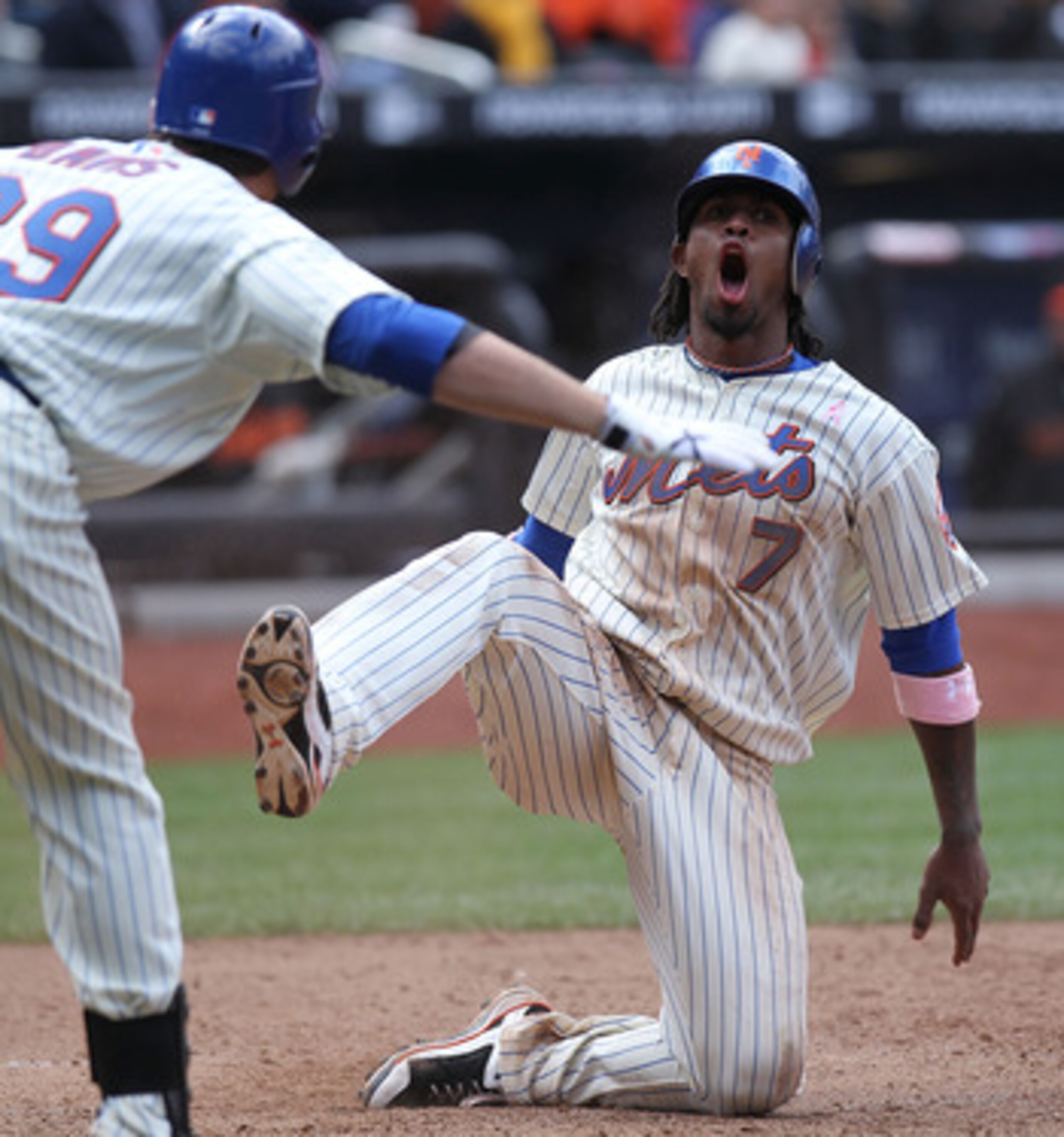 NEW YORK - MAY 09:  Jose Reyes #7 of the New York Mets scores on a David Wright sacrifice fly against the San Francisco Giants at Citi Field on May 9, 2010 in the Flushing neighborhood of the Queens borough of New York City.  (Photo by Nick Laham/Getty Im