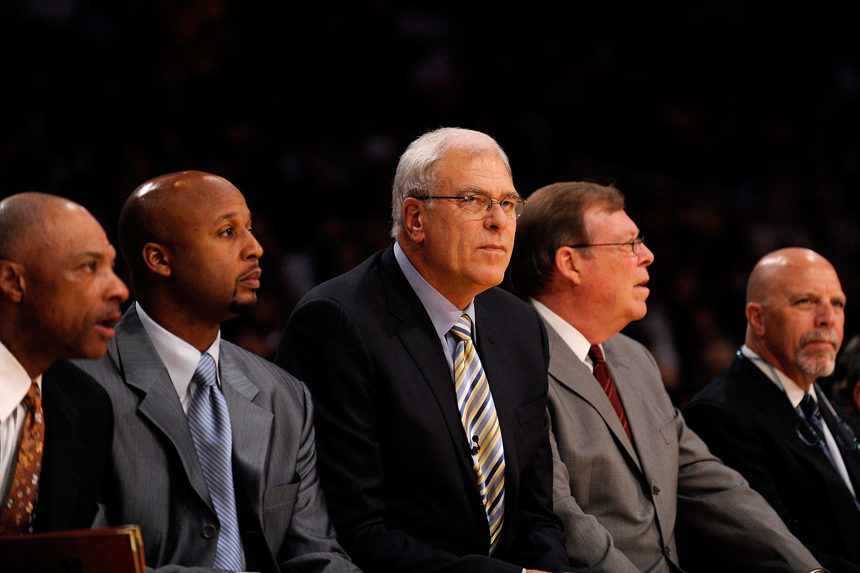 LOS ANGELES, CA - OCTOBER 27:  (L-R) Assistant coach Jim Cleamons, assistant coach Brian Shaw, head coach Phil Jackson, assistant coach Frank Hamblen and athletic trainer Gary Vitti of the Los Angeles Lakers sit during the season opening game against the