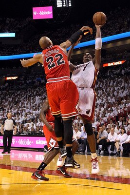 MIAMI, FL - MAY 22:  Chris Bosh #1 of the Miami Heat attempts a shot against Taj Gibson #22 of the Chicago Bulls in Game Three of the Eastern Conference Finals during the 2011 NBA Playoffs on May 22, 2011 at American Airlines Arena in Miami, Florida.  NOT