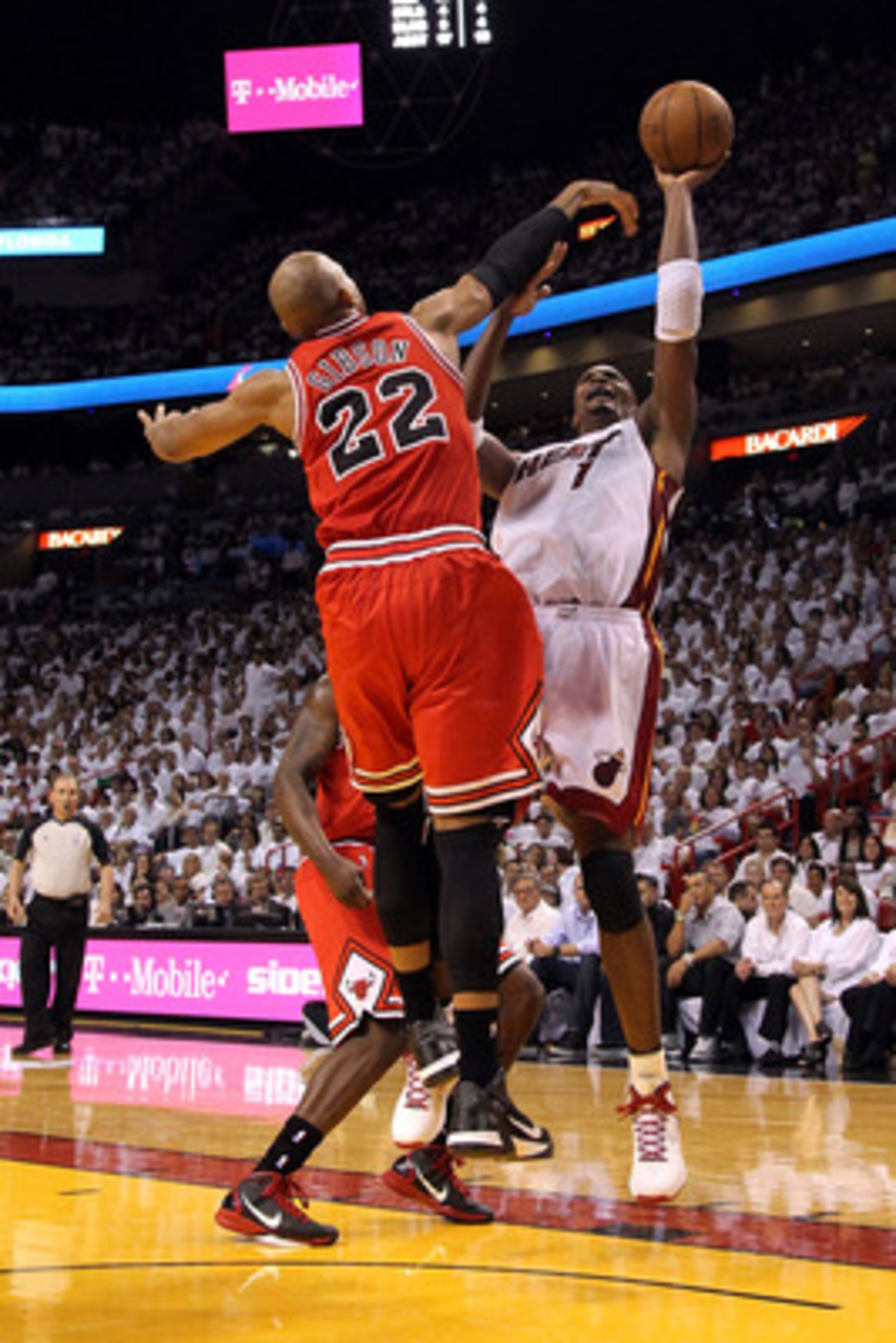 MIAMI, FL - MAY 22:  Chris Bosh #1 of the Miami Heat attempts a shot against Taj Gibson #22 of the Chicago Bulls in Game Three of the Eastern Conference Finals during the 2011 NBA Playoffs on May 22, 2011 at American Airlines Arena in Miami, Florida.  NOT