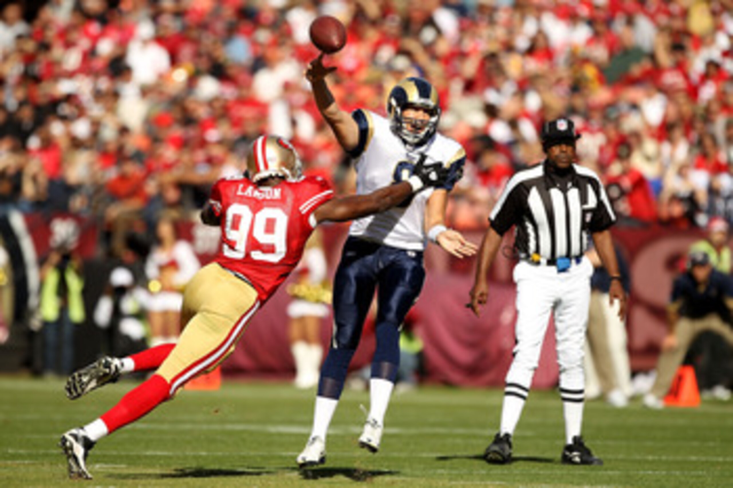 SAN FRANCISCO - NOVEMBER 14:  Sam Bradford #8 of the St. Louis Rams throws the ball as he is hit by Manny Lawson #99 of the San Francisco 49ers at Candlestick Park on November 14, 2010 in San Francisco, California.  (Photo by Ezra Shaw/Getty Images)