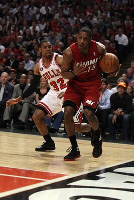 CHICAGO, IL - MAY 18: Mario Chalmers #15 of the Miami Heat drives past C.J. Watson #32 of the Chicago Bulls in Game Two of the Eastern Conference Finals during the 2011 NBA Playoffs on May 18, 2011 at the United Center in Chicago, Illinois. The Heat won 8