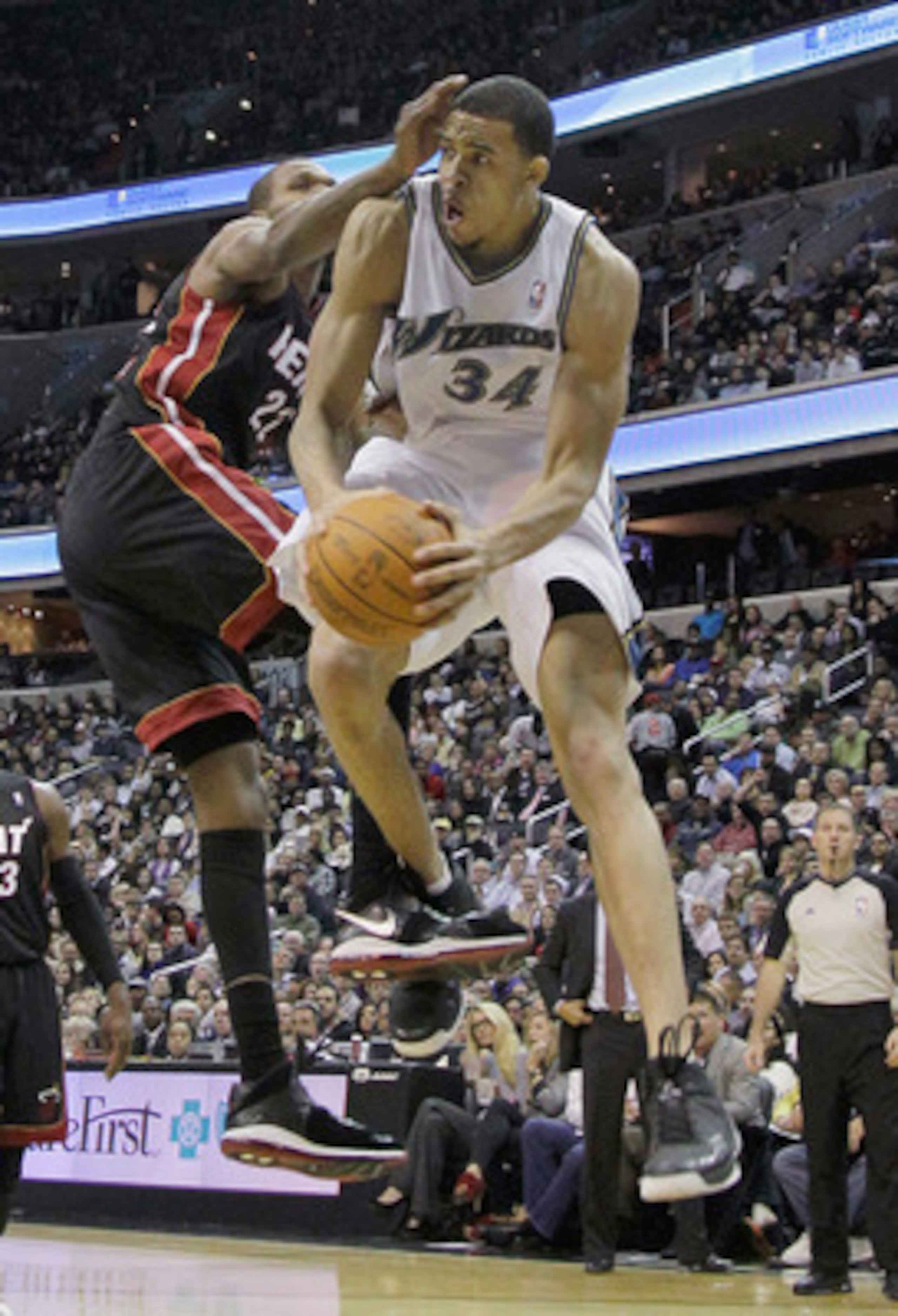 WASHINGTON, DC - MARCH 30: JaVale McGee #34 of the Washington Wizards puts up a shot while being guarded by James Jones #22 of the Miami Heat during the second half at the Verizon Center on March 30, 2011 in Washington, DC. NOTE TO USER: User expressly ac