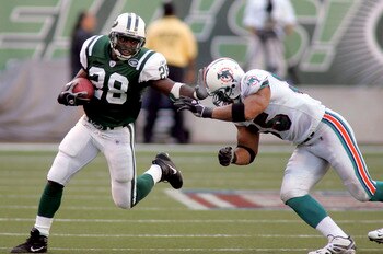 EAST RUTHERFORD, NJ - SEPTEMBER 18:  Running back Curtis Martin #28 of the New York Jets runs the ball against linebacker Junior Seau #55 of the Miami Dolphins on September 18, 2005 at Giants Stadium in East Rutherford, New Jersey. The Jets defeated the D