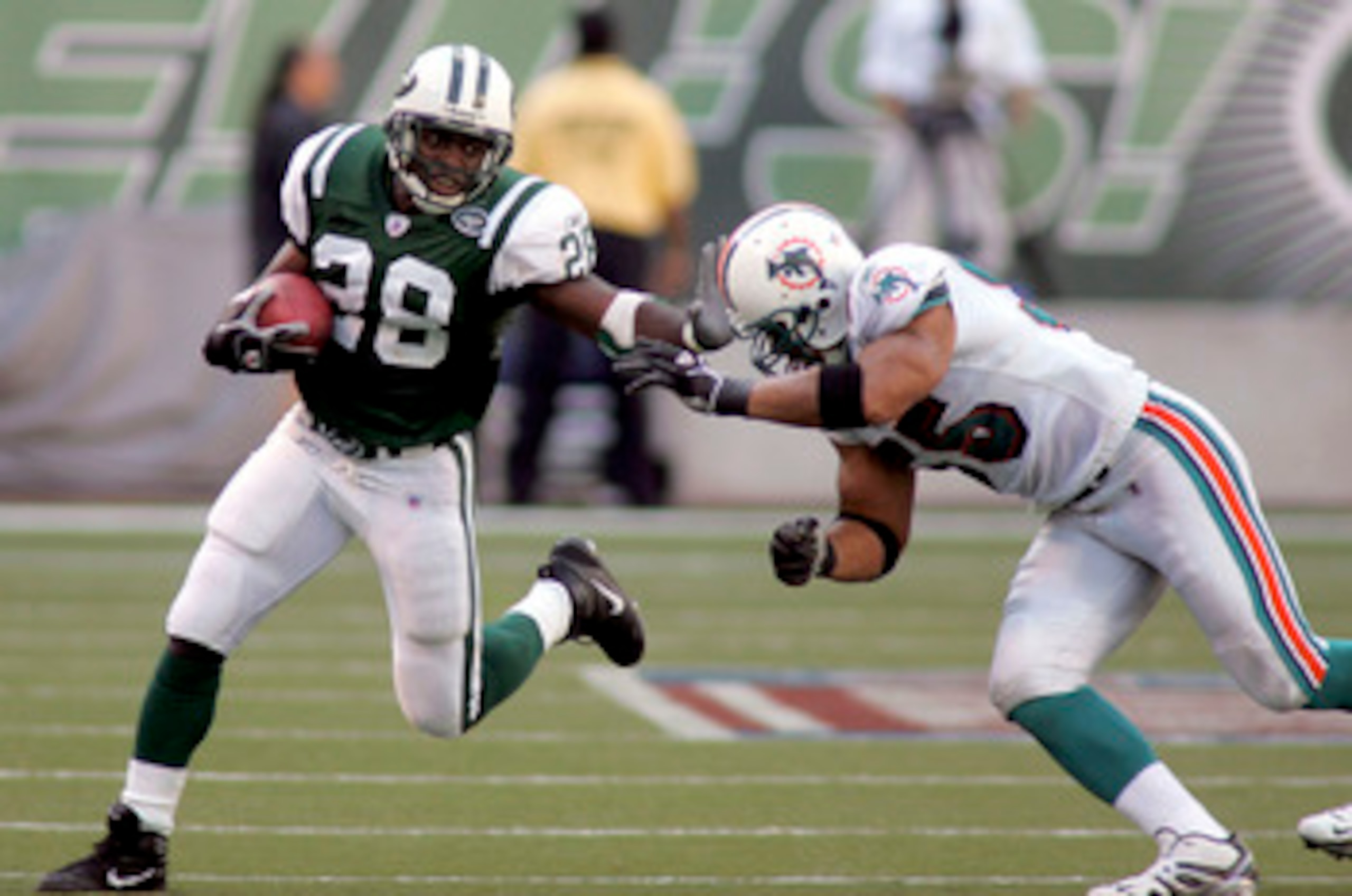 EAST RUTHERFORD, NJ - SEPTEMBER 18:  Running back Curtis Martin #28 of the New York Jets runs the ball against linebacker Junior Seau #55 of the Miami Dolphins on September 18, 2005 at Giants Stadium in East Rutherford, New Jersey. The Jets defeated the D